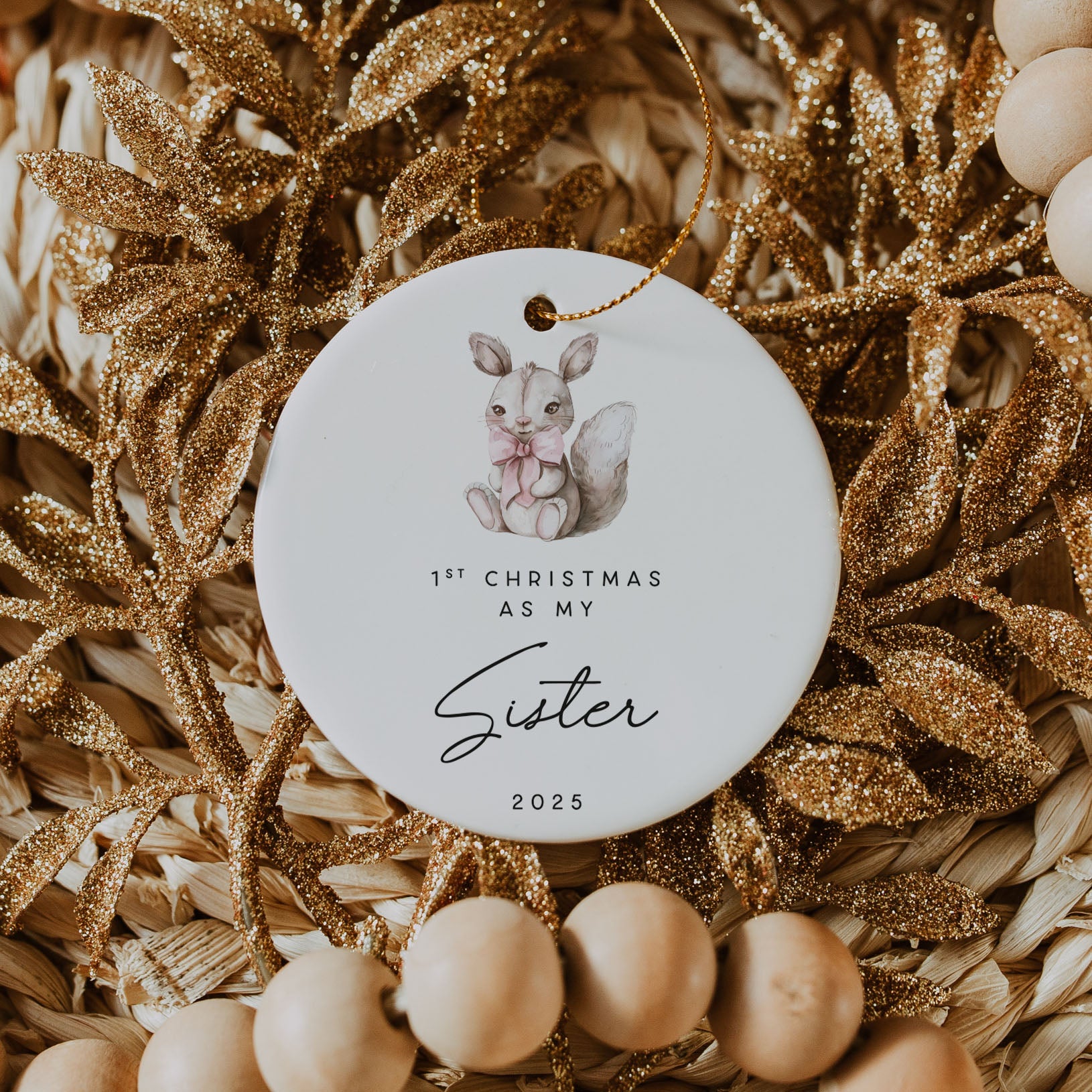 Decorative ornament with a baby squirrel illustration and text on a textured background.