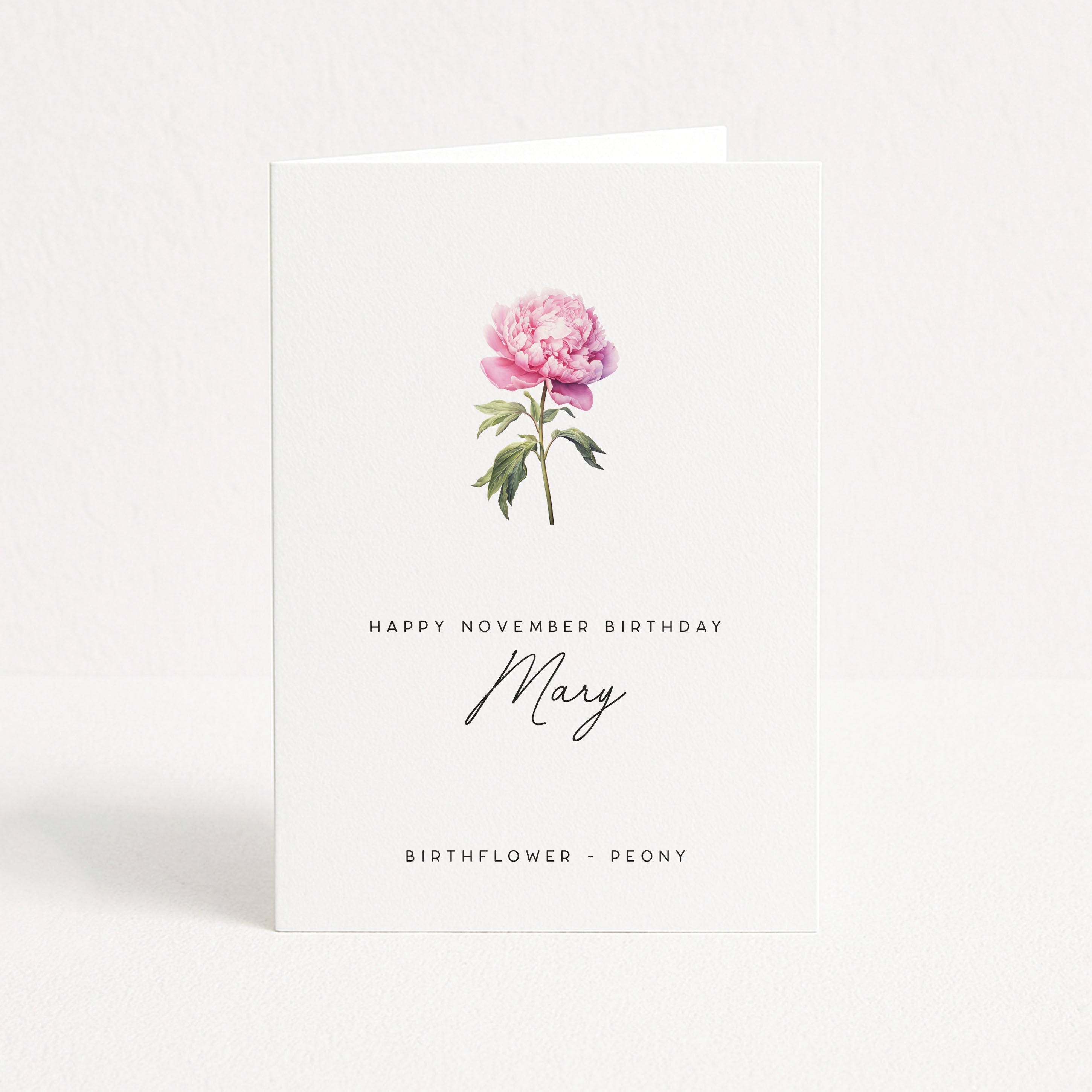 Greeting card with a pink peony and text 'Happy November Birthday Mary' on a white background