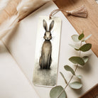 Acrylic Bookmark with a rabbit illustration on a wooden surface with eucalyptus leaves