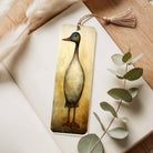Bookmark with duck illustration on a wooden surface with eucalyptus leaves