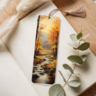 Bookmark with autumn landscape design on a wooden surface with eucalyptus leaves