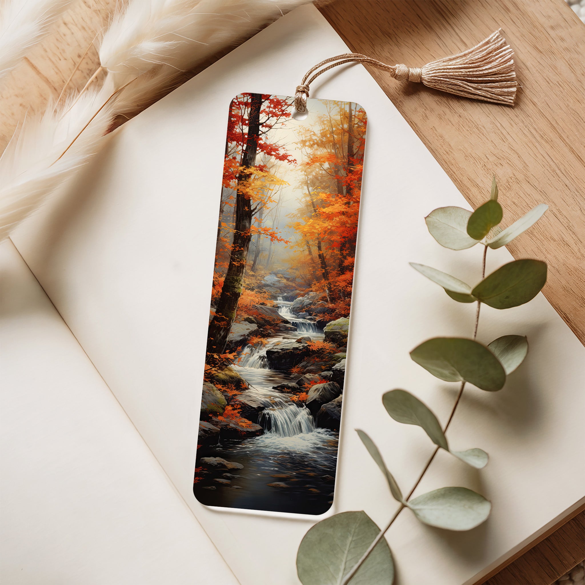 Bookmark with autumn forest design on a wooden surface with eucalyptus leaves
