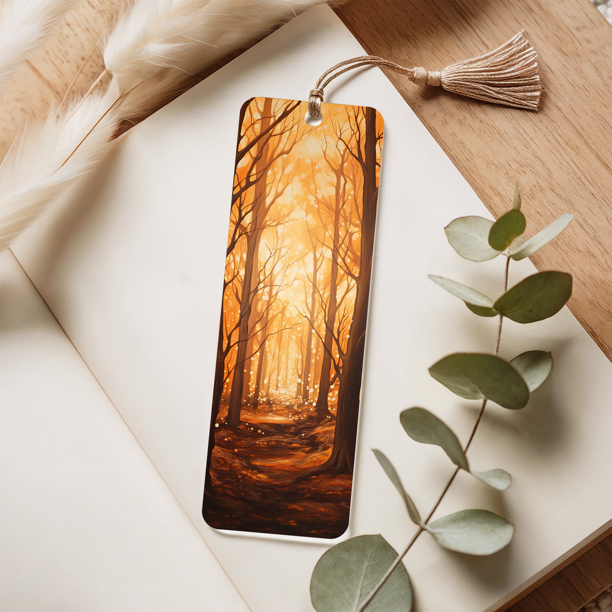 Acrylic bookmark with forest design on a white surface with eucalyptus leaves