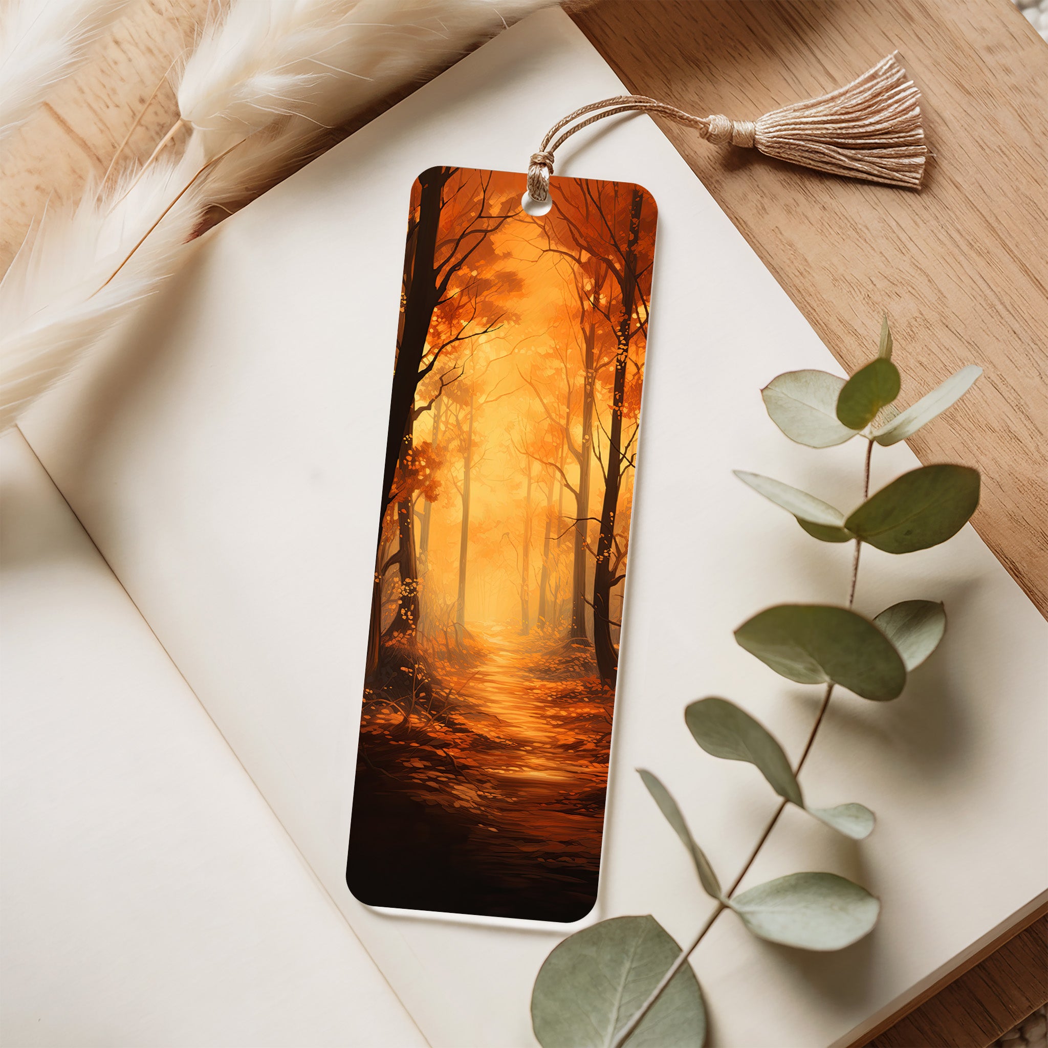 Acrylic bookmark with a forest design on an open book with eucalyptus leaves.