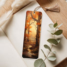 Bookmark with autumn tree design on a wooden surface with eucalyptus leaves