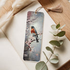 Bookmark with bird and floral design on a wooden surface with leaves
