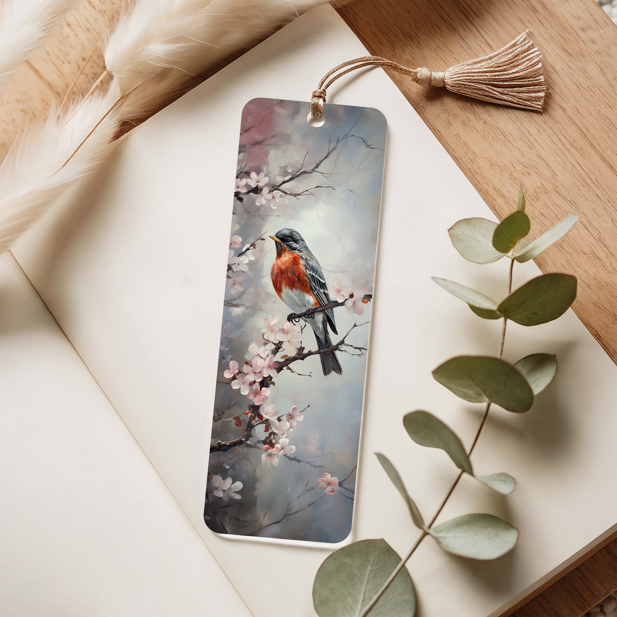 Bookmark with bird and floral design on a wooden surface with leaves