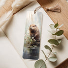 Bookmark with a beaver design on a wooden surface with eucalyptus leaves