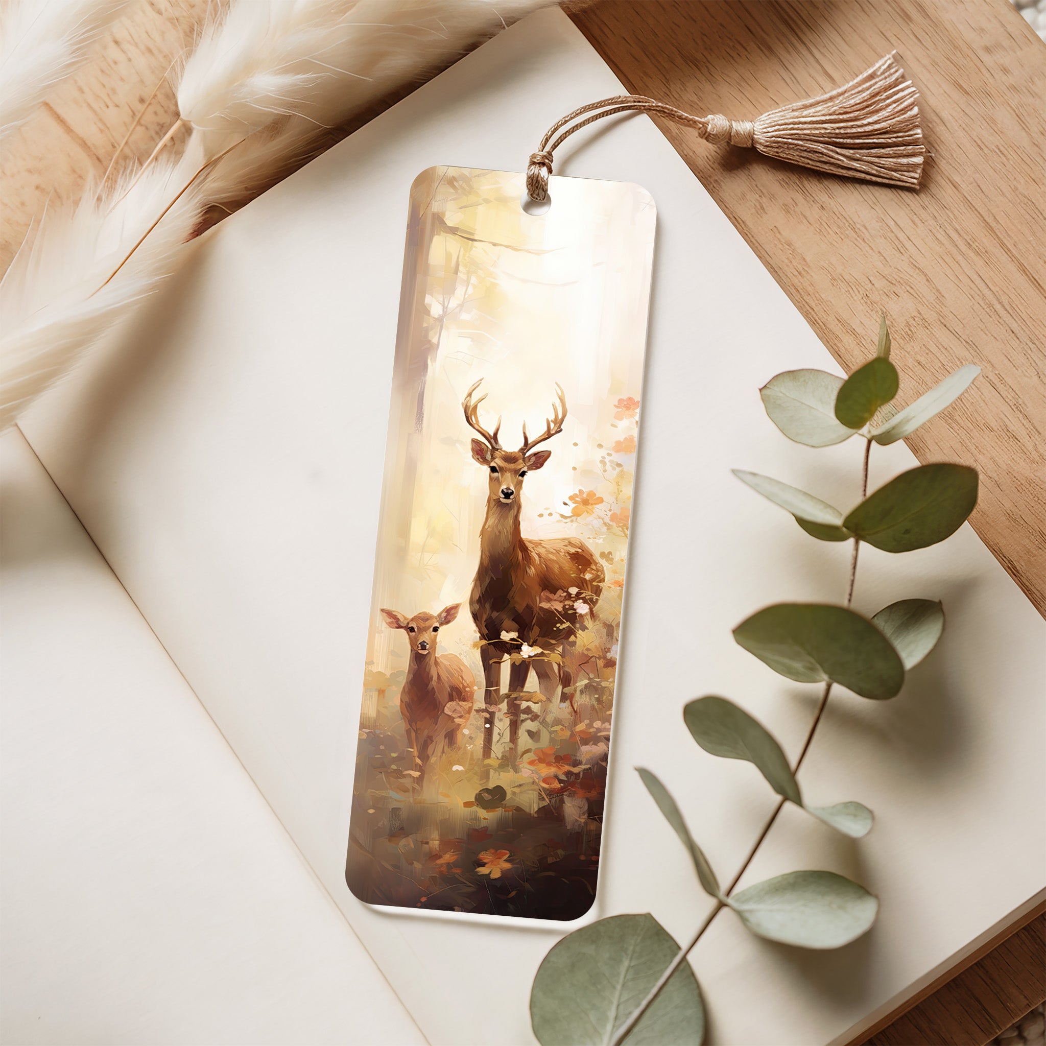 Bookmark with deer design on a wooden surface with leaves