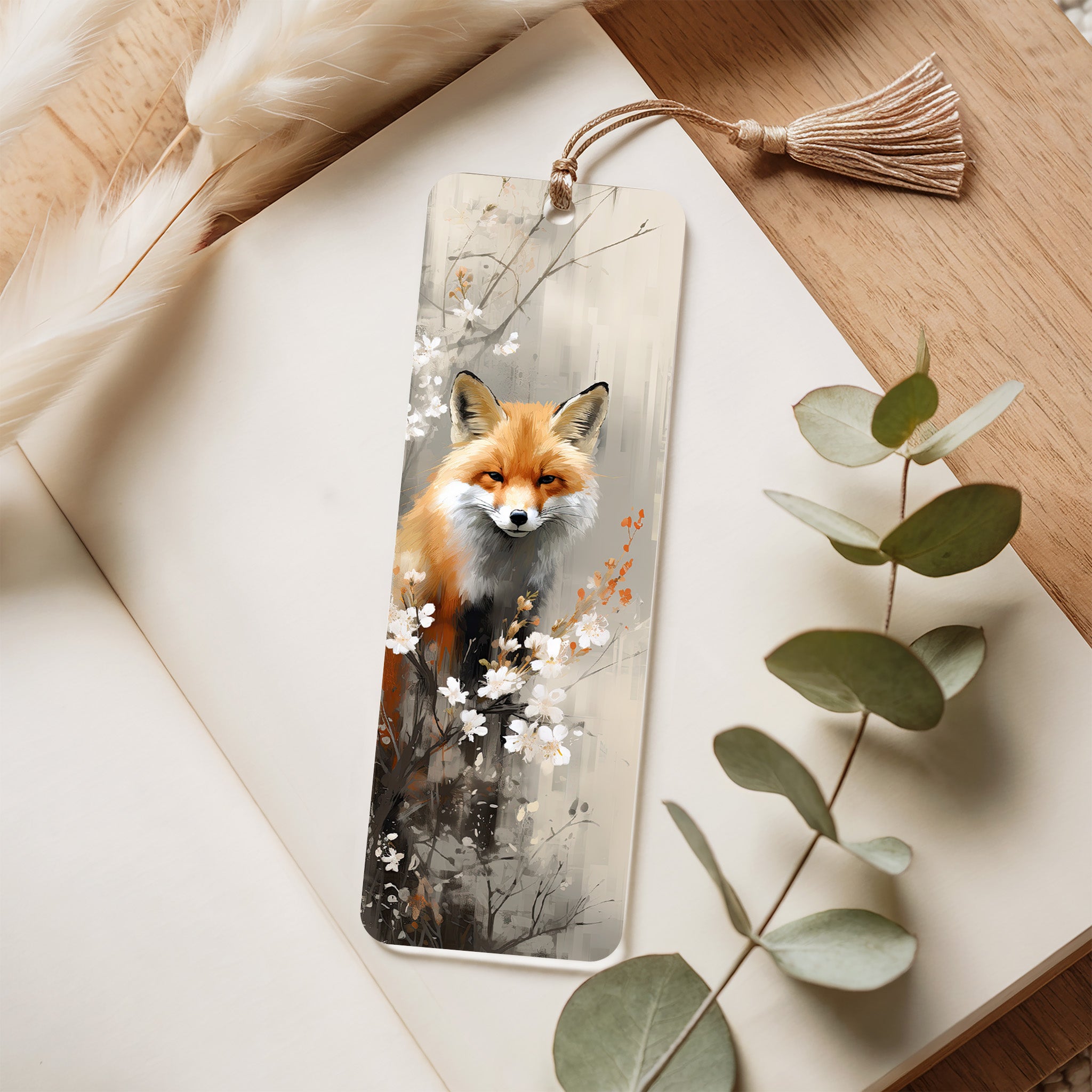 Bookmark with a fox design on a wooden surface with eucalyptus leaves