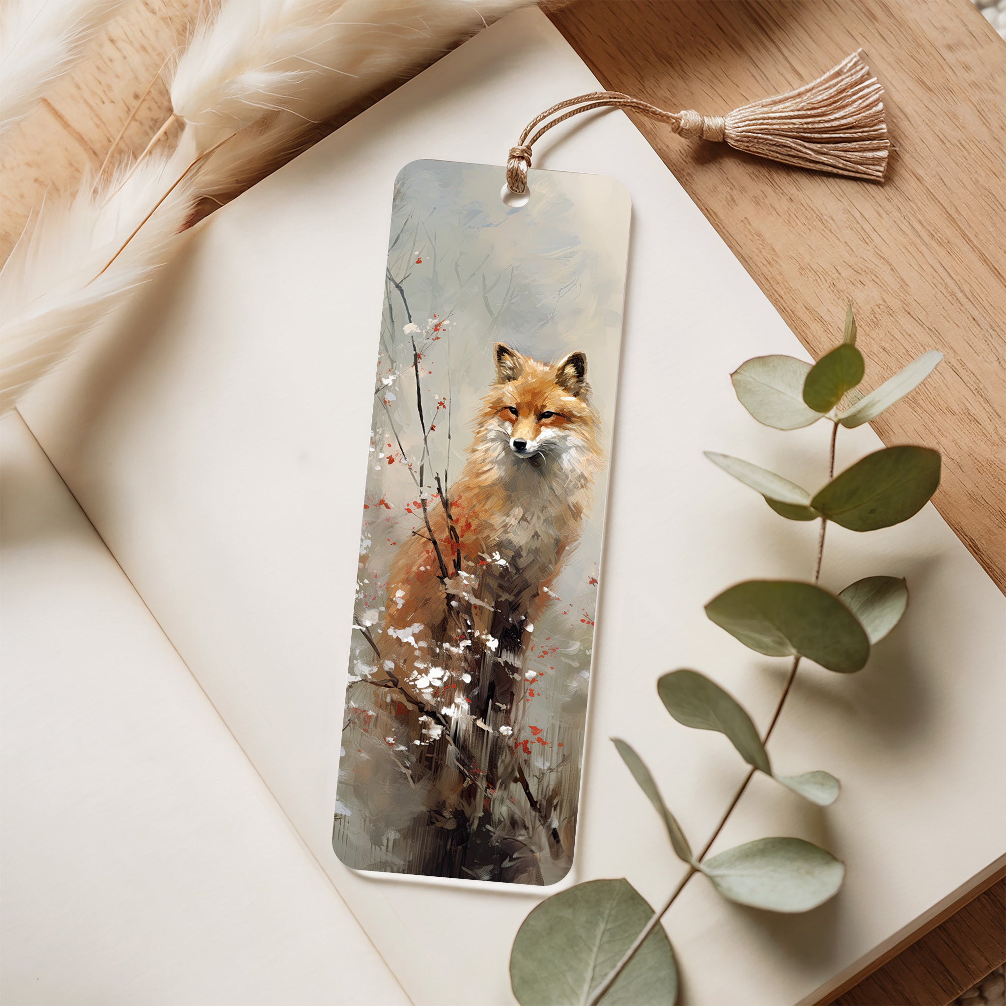 Bookmark with a fox design on a wooden surface with eucalyptus leaves
