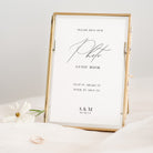 Gold-framed photo guest book sign with text on a white background
