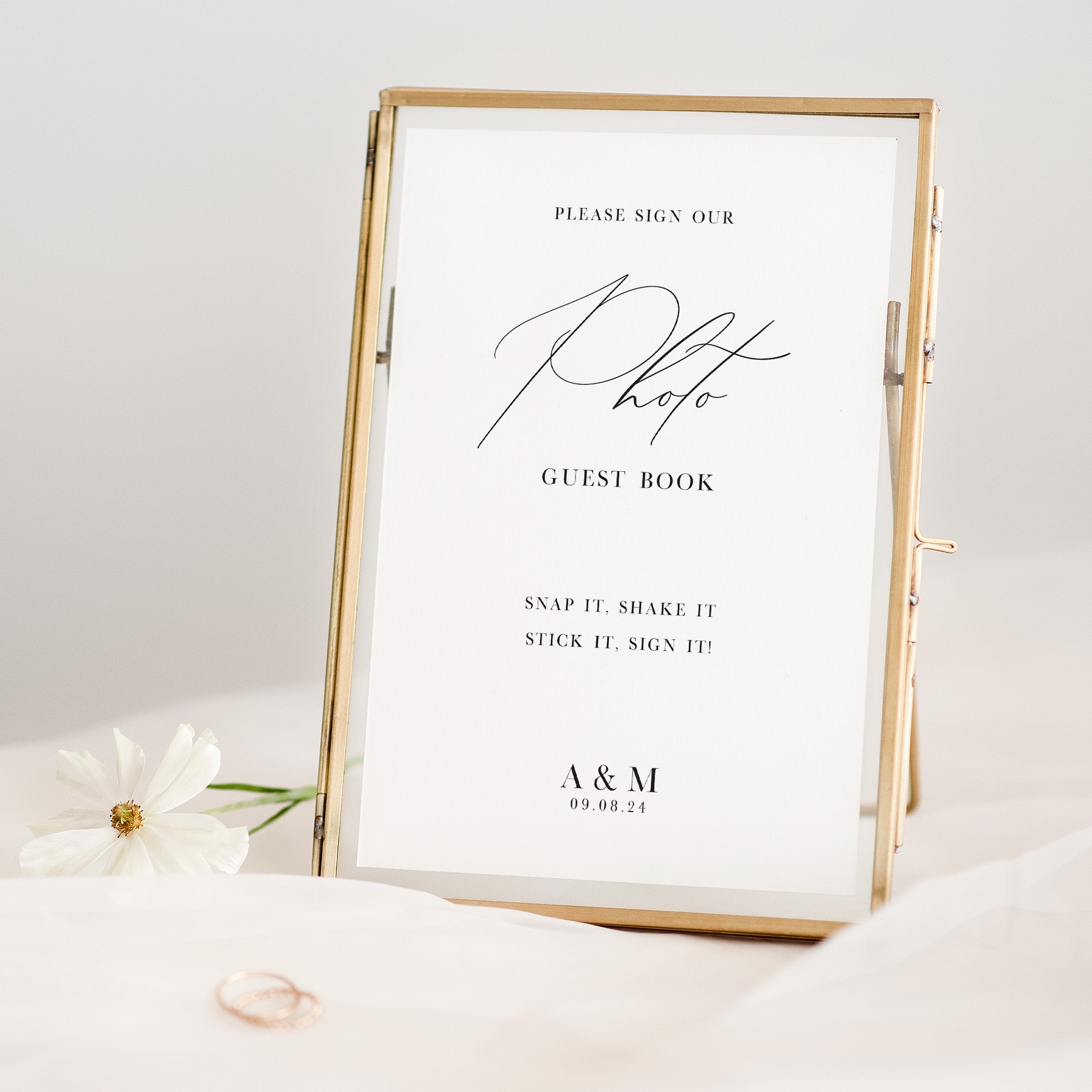 Gold-framed photo guest book sign with text on a white background