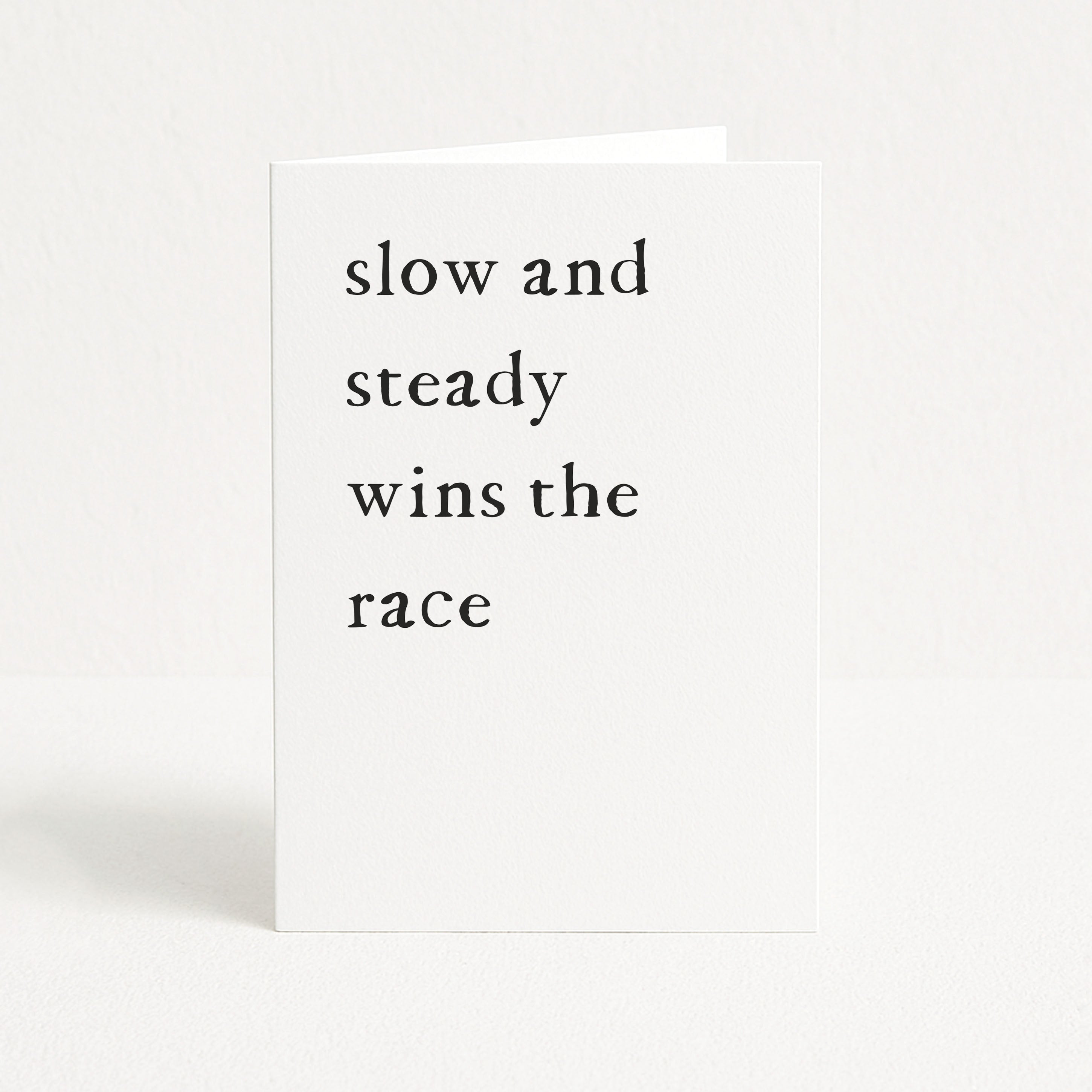Birthday card with 'slow and steady wins the race' text on a white background