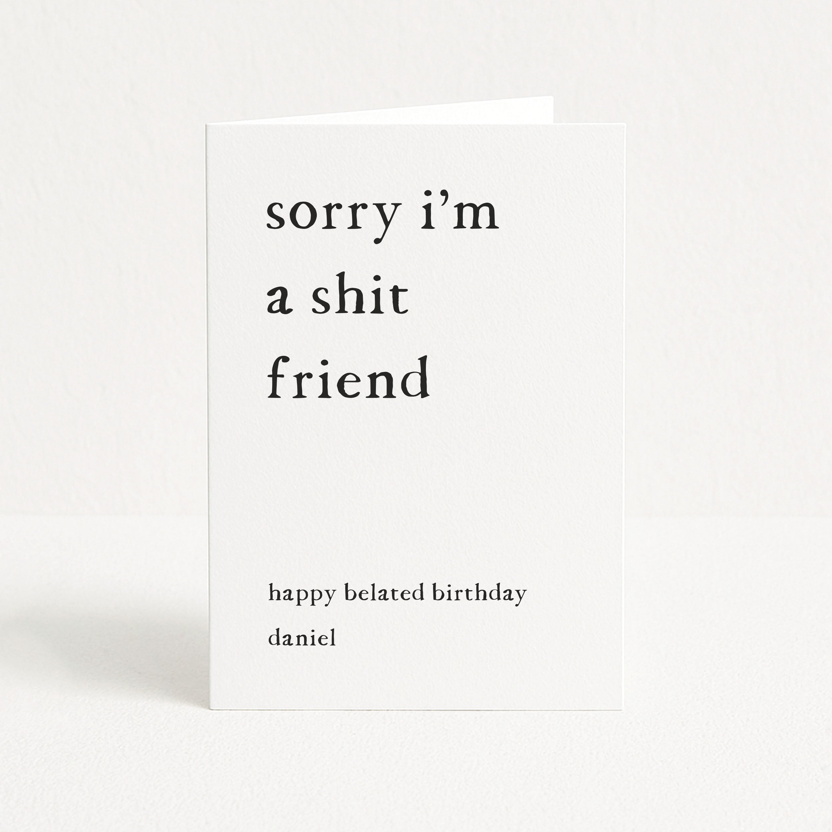 Greeting card with text 'sorry i'm a shit friend' on a white background