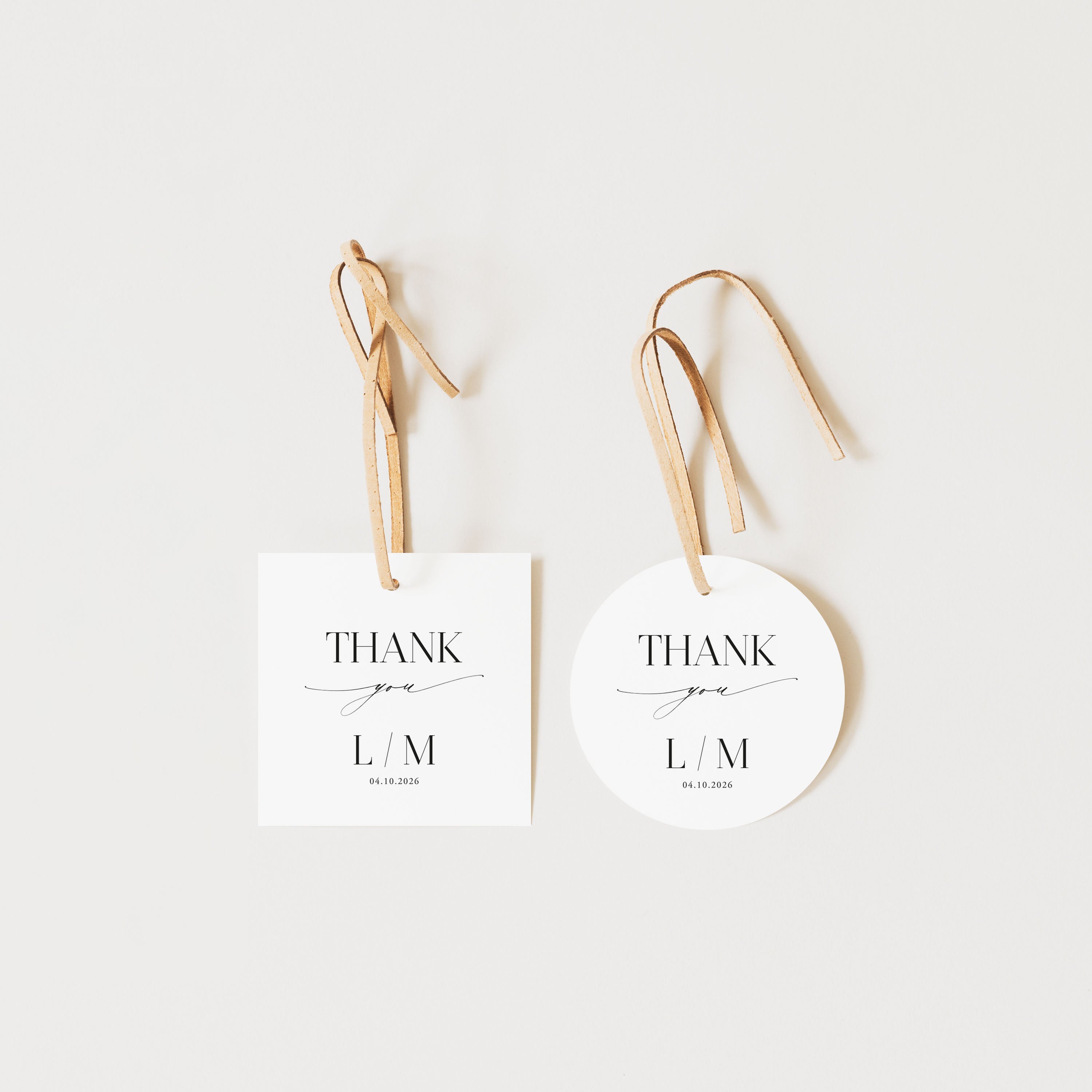 Two white tags with 'Thank you L/M' text on a light beige background