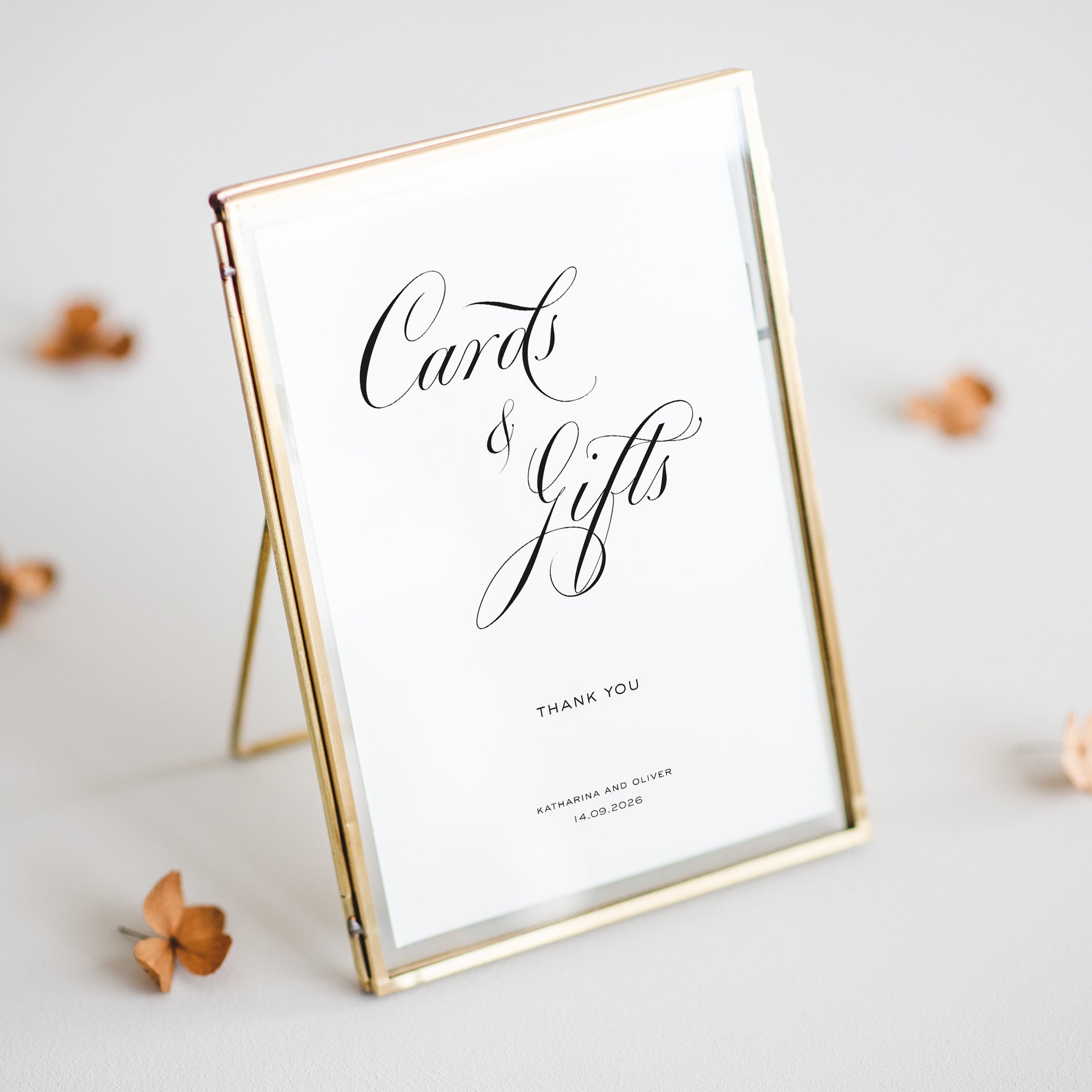 Gold-framed sign with 'Cards & Gifts' text on a light background