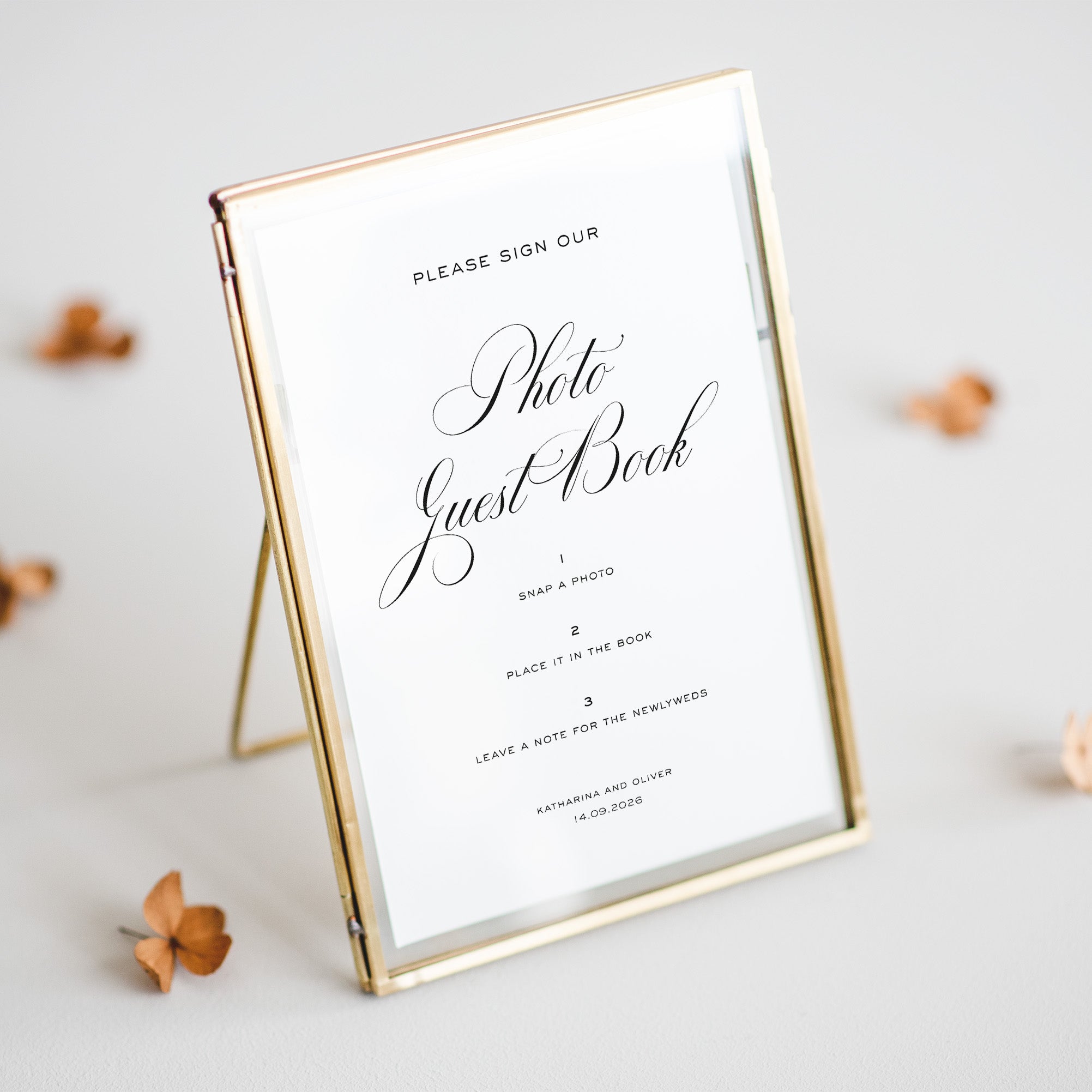 Gold-framed sign for a photo guest book on a light background