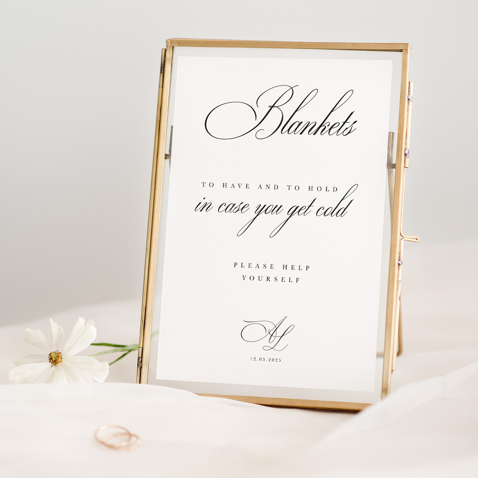 Decorative blankets sign for wedding with text in a gold frame on a white background