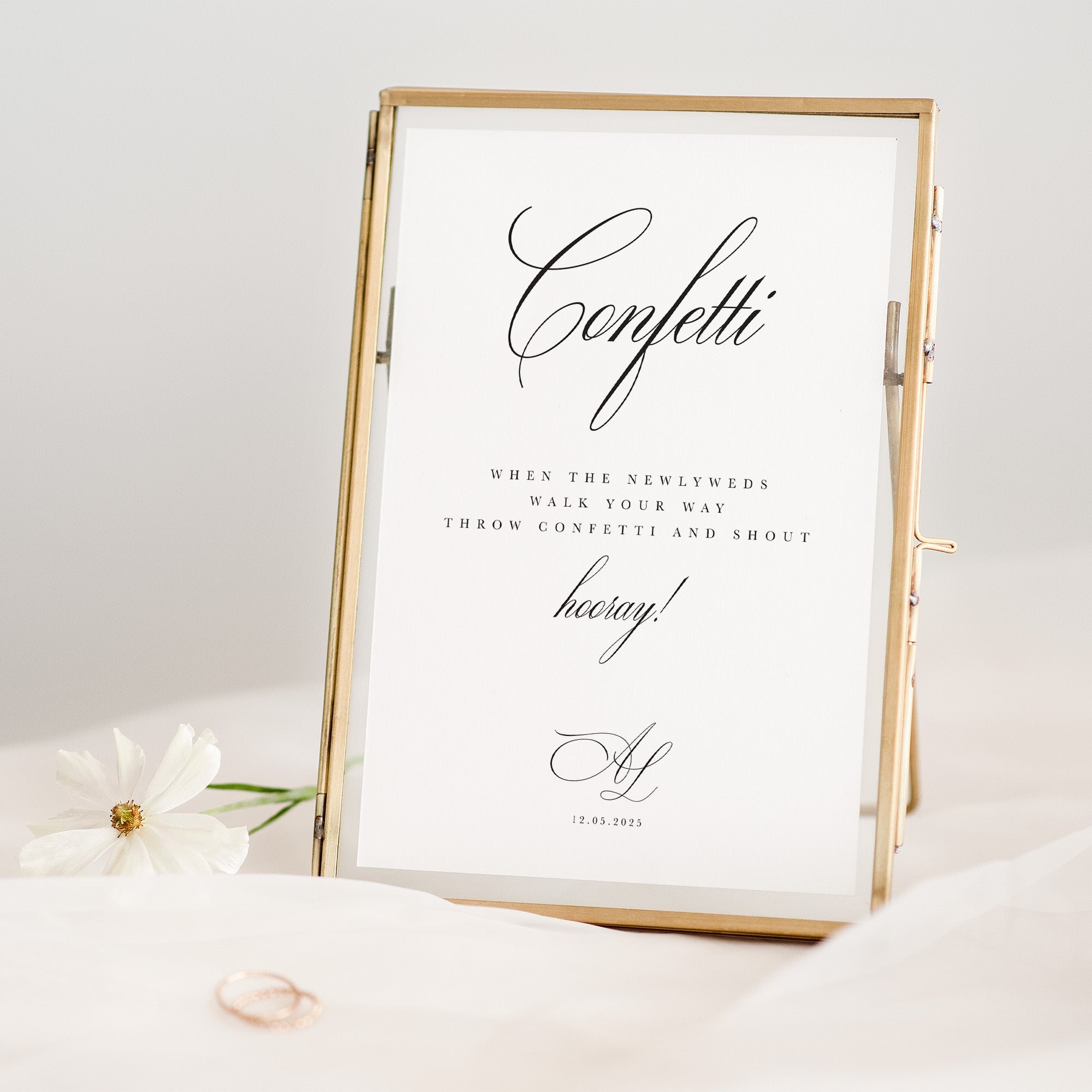 Decorative sign with 'Confetti' text in a gold frame on a white background
