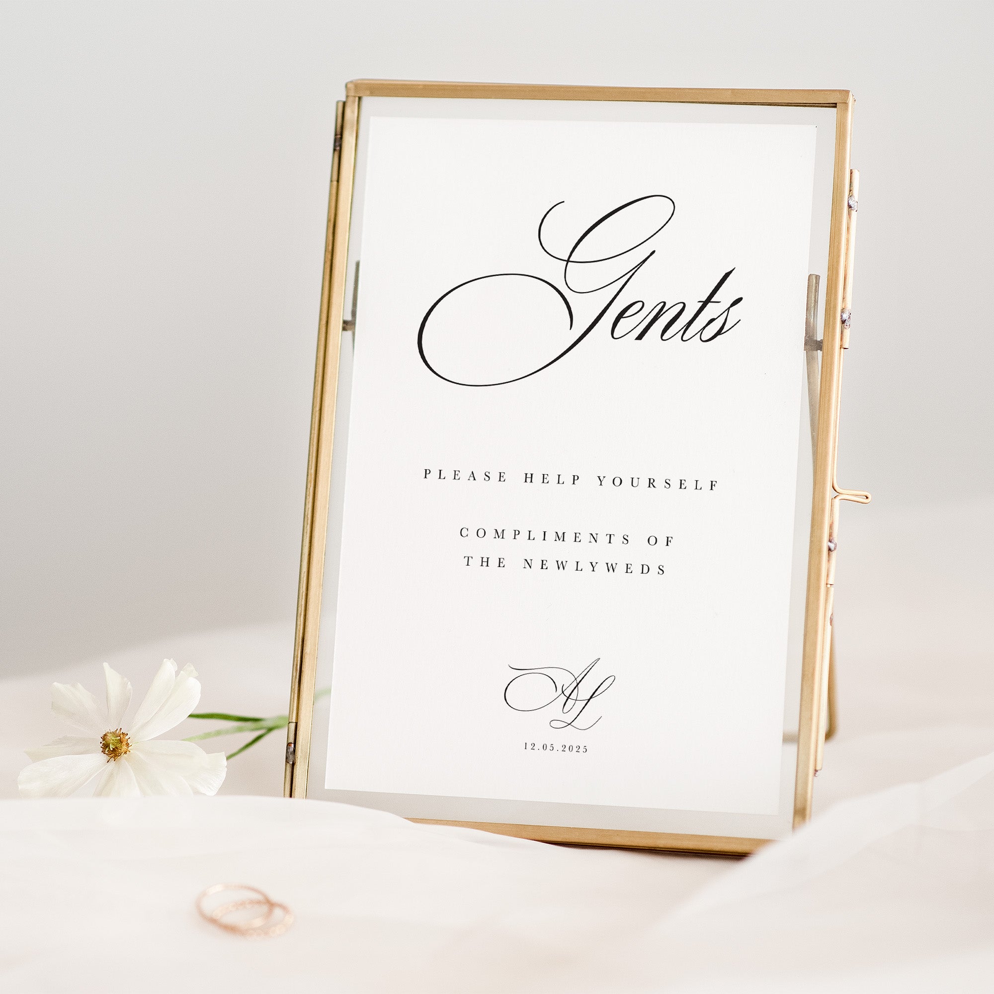 Decorative sign with 'Gents' and wedding date in a gold frame on a white background