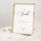 Gold-framed print with 'Let Love Sparkle' text on a white background