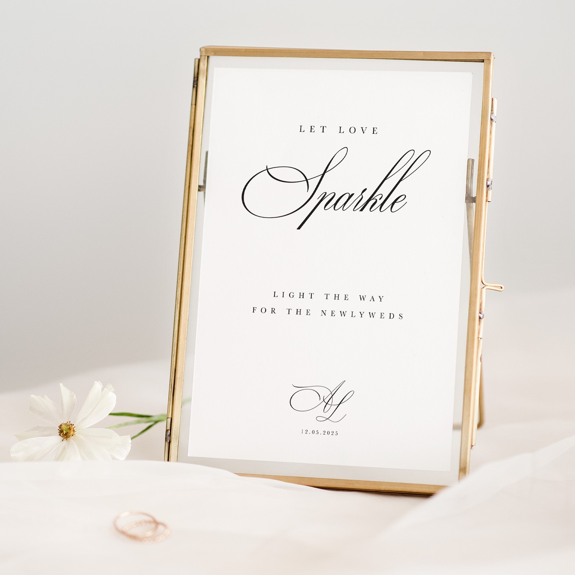 Gold-framed print with 'Let Love Sparkle' text on a white background
