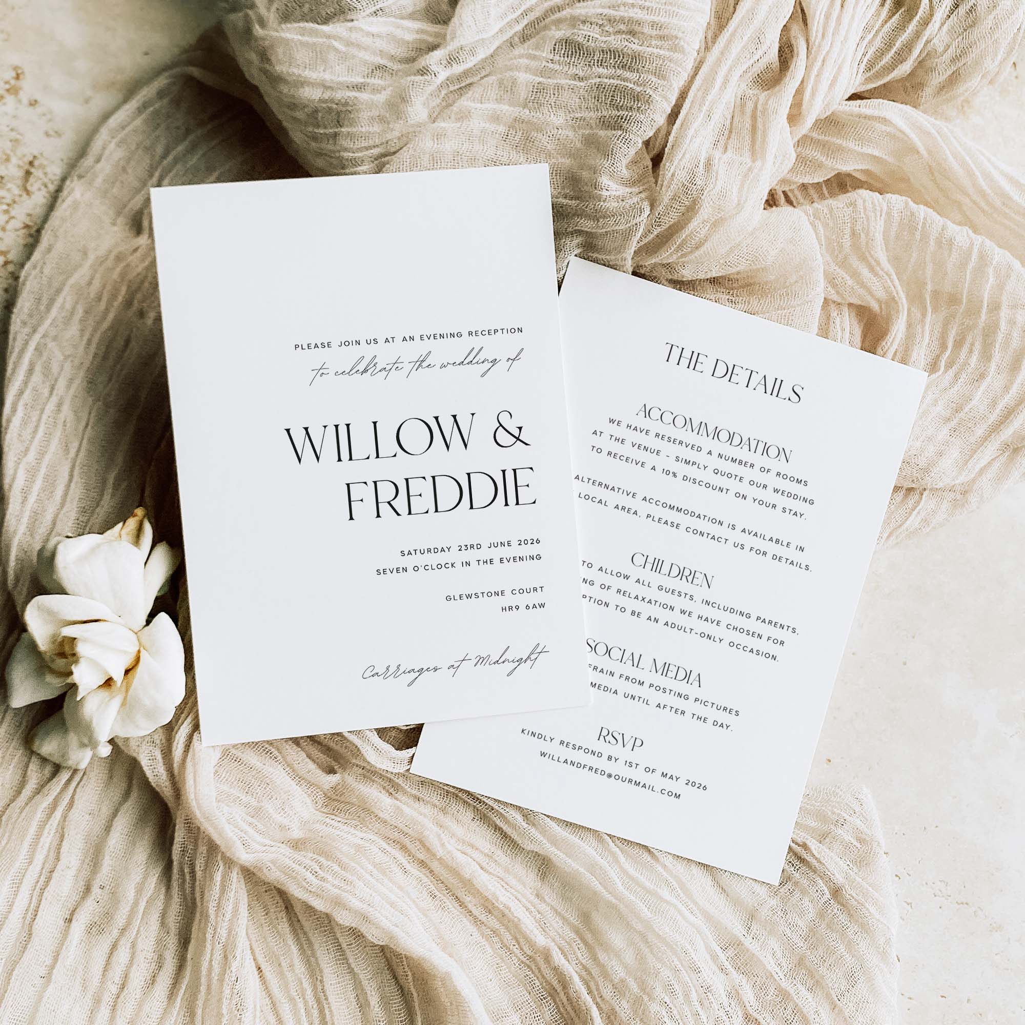 Wedding reception invitation cards for Willow & Freddie on a soft fabric background with flowers.