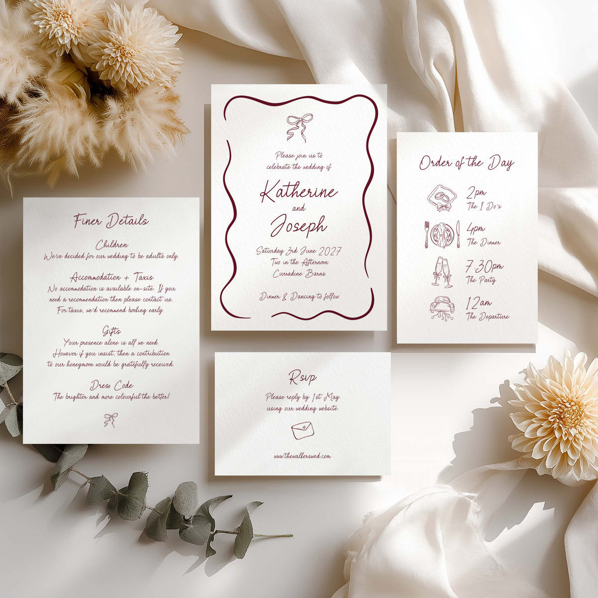 A flat lay of a whimsical wedding invitation suite showing an invitation, details card, itinerary and RSVP card