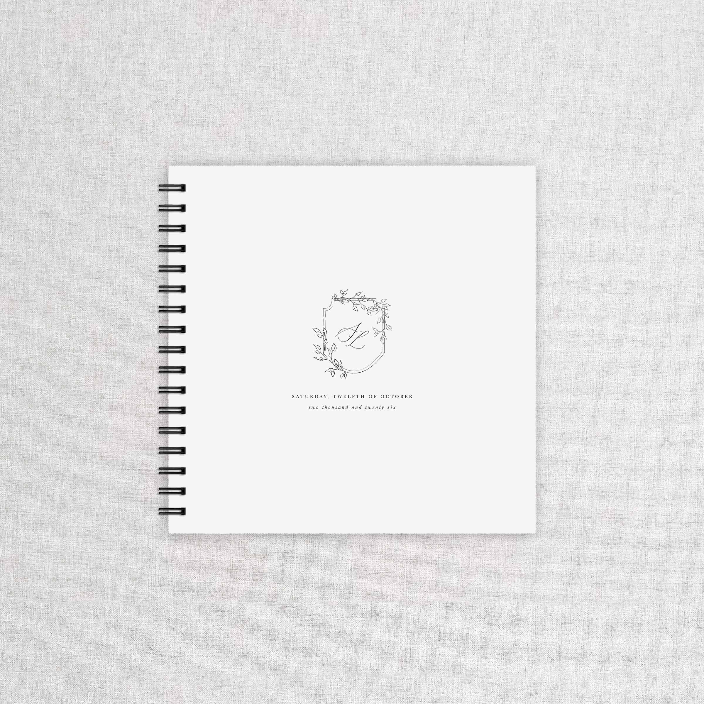 Wedding guest book with a monogram and floral crest