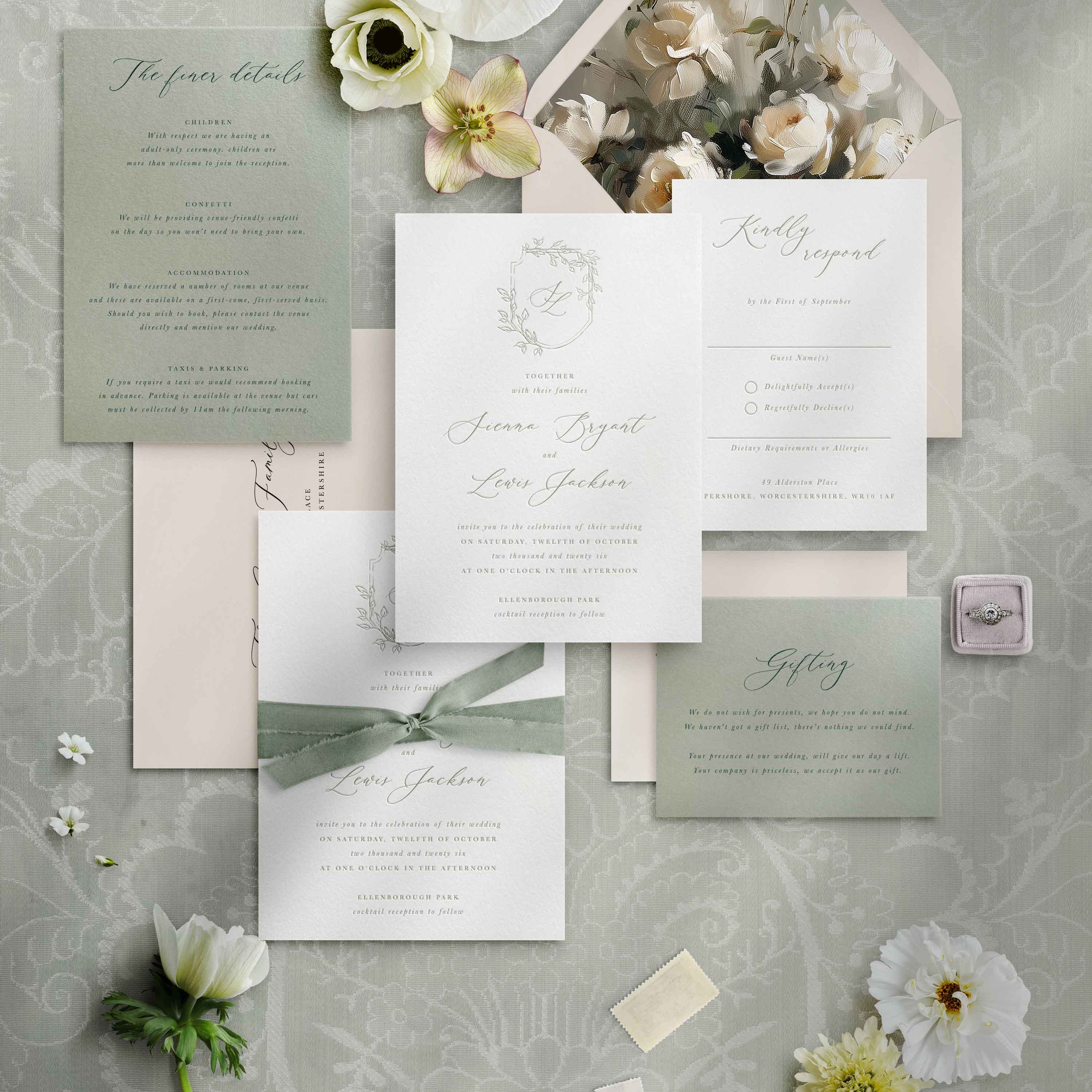 Wedding invitation set with floral elements on a textured gray background