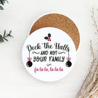 Round coaster with Christmas-themed text and decorations on a white surface.