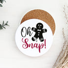 Coaster with 'Oh Snap!' gingerbread man design on a white surface