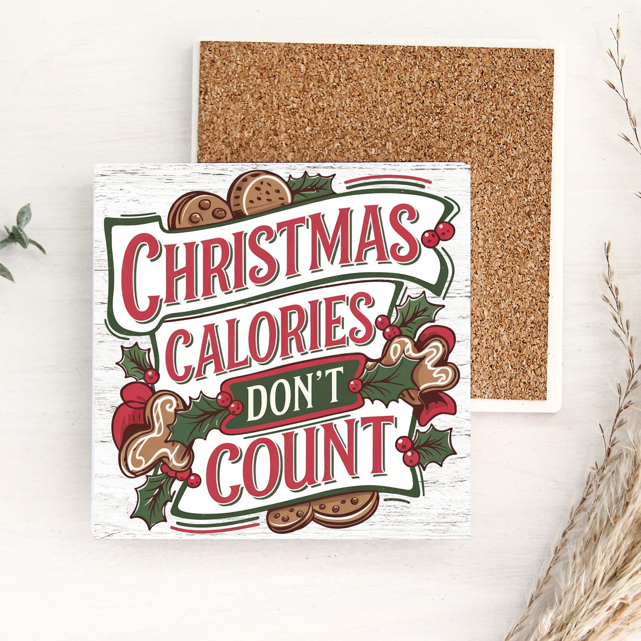 Christmas-themed coaster with 'Christmas calories don't count' text and cork backing for reverse