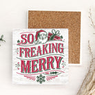 Christmas-themed coaster with Santa Claus and text on a cork surface.