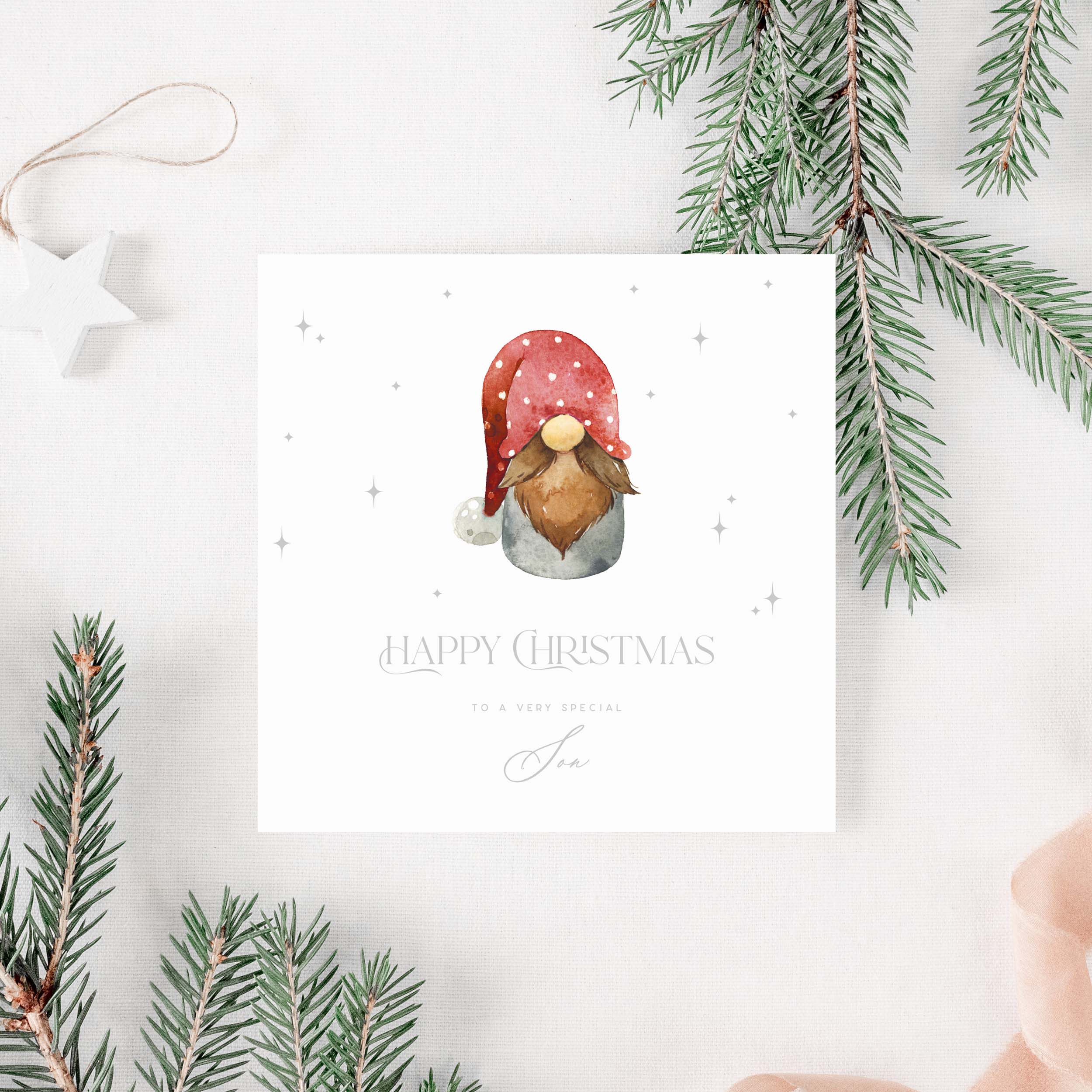 Christmas card for son with a gnome illustration and 'Happy Christmas' text, surrounded by pine branches.