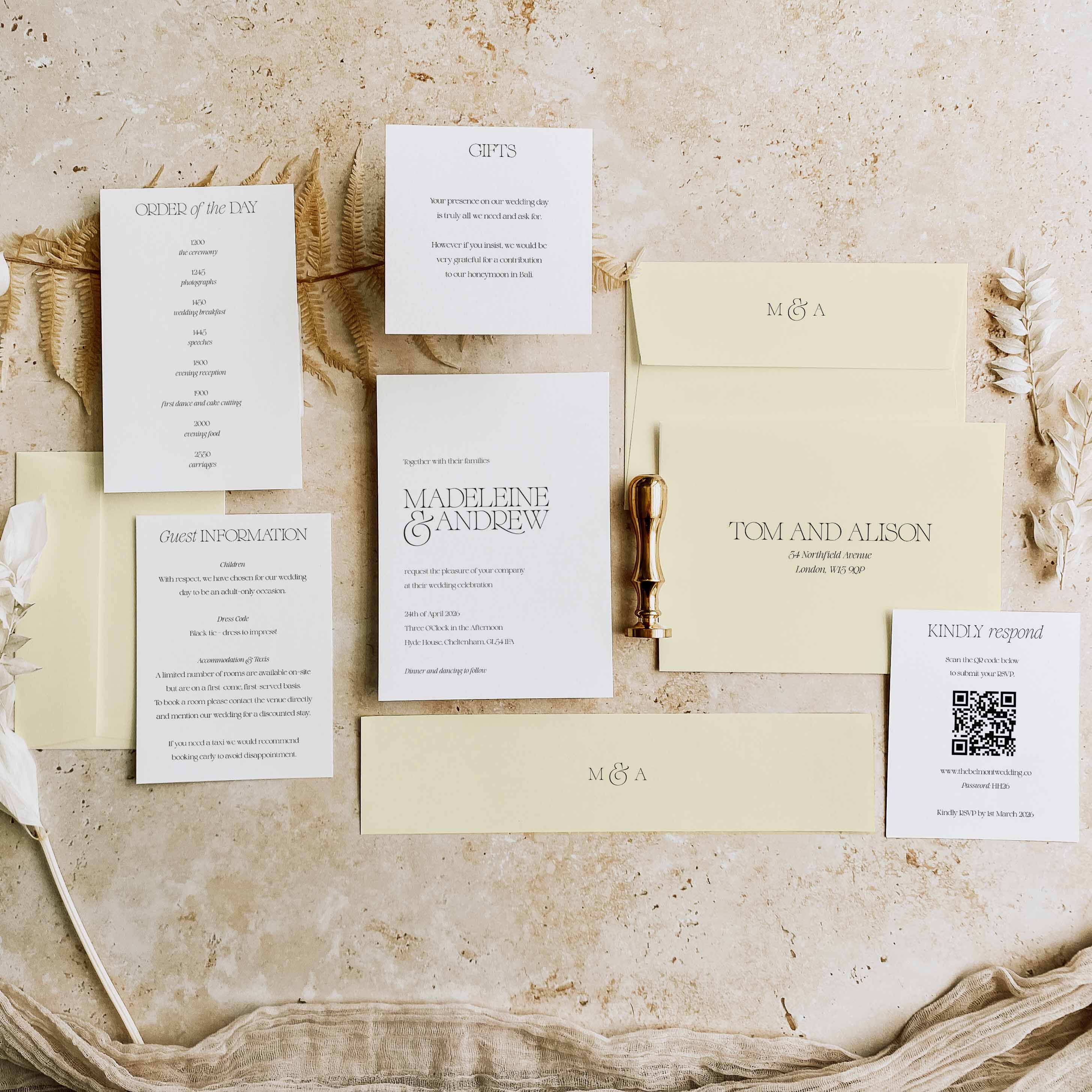 Wedding invitation set with envelopes and cards on a textured surface