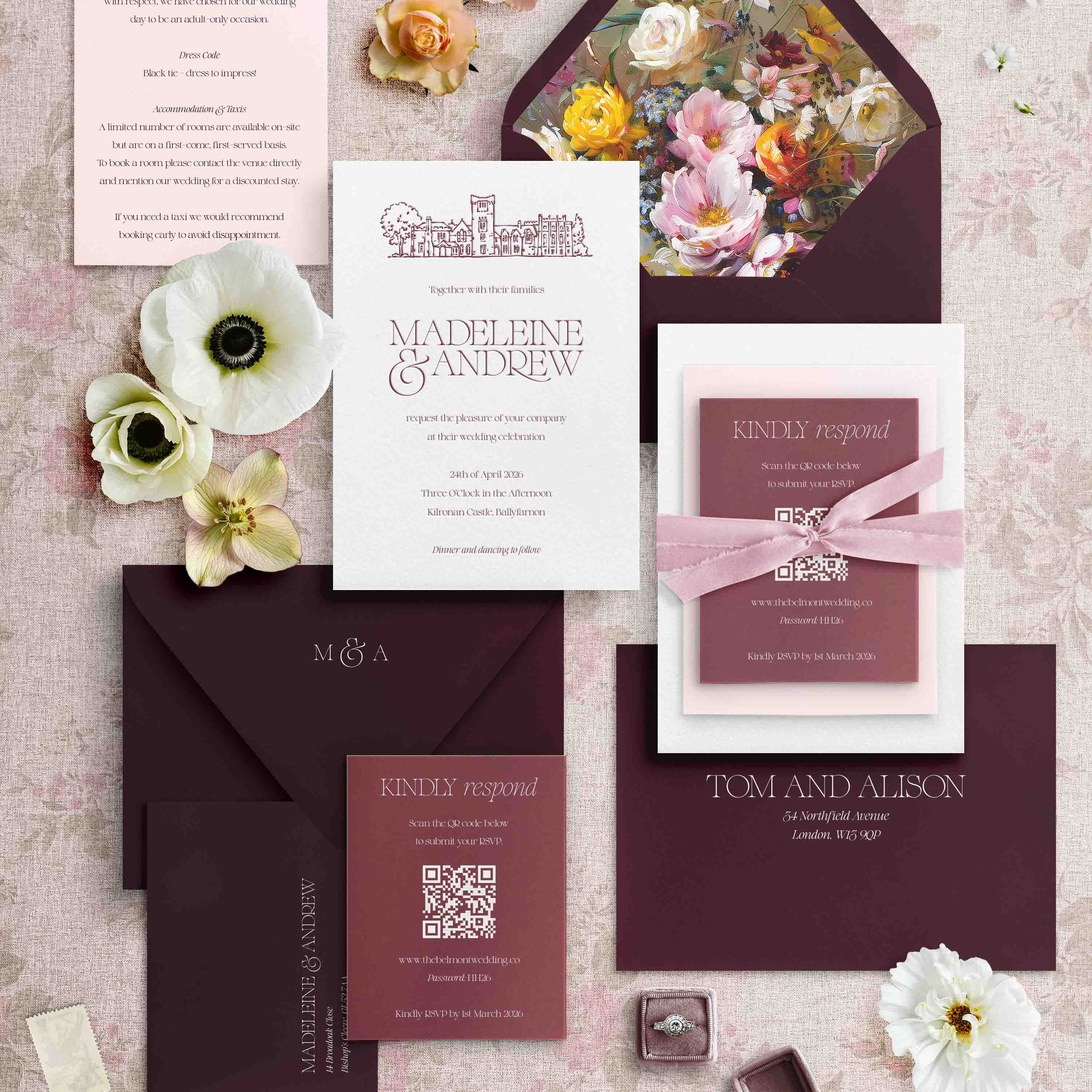 Letterpress Wedding invitation set with floral design and stationery items on a textured surface.