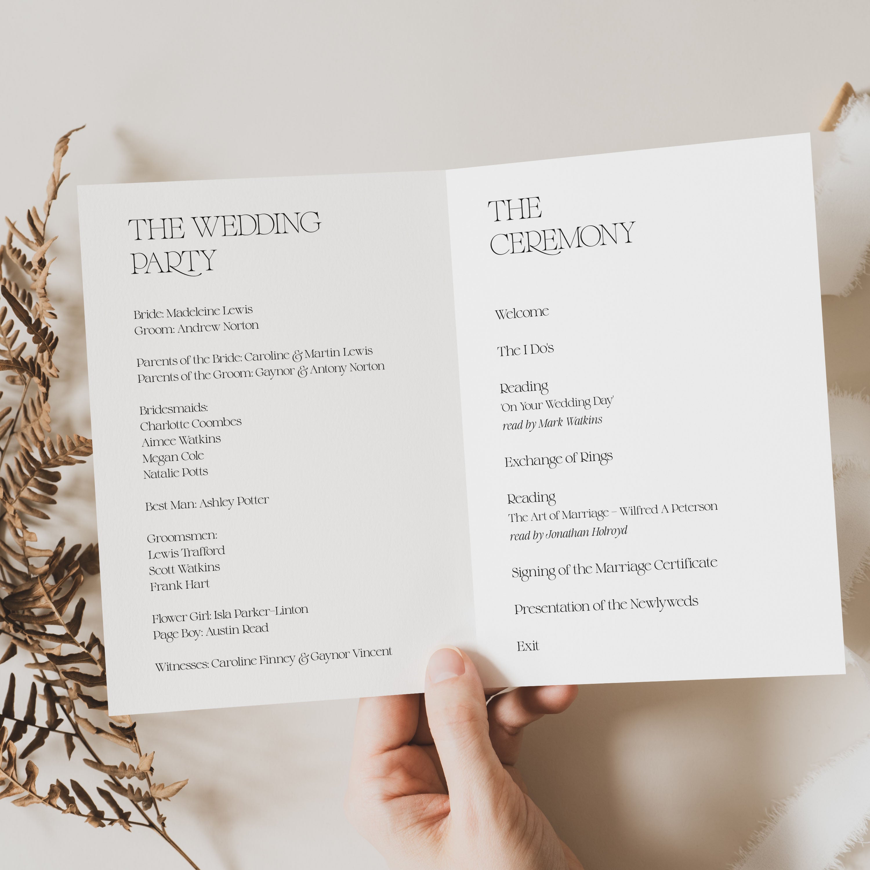 Wedding ceremony program held open by a hand with decorative elements.