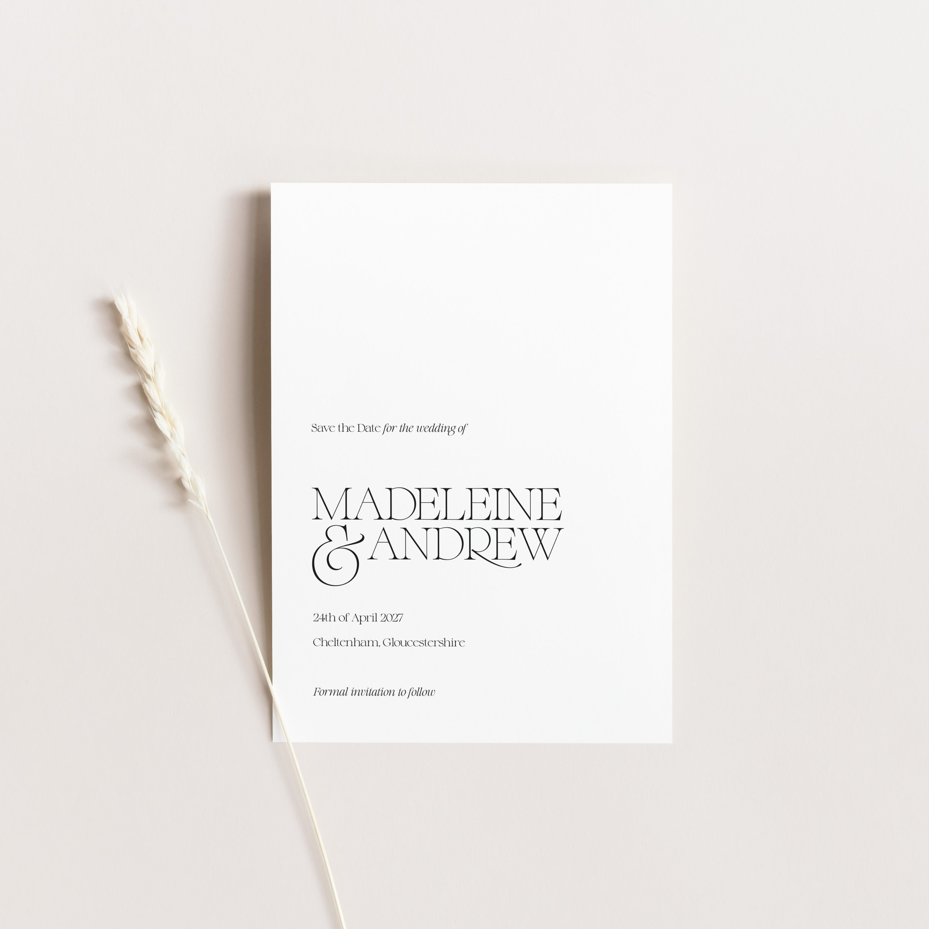 White save the date wedding card with black text on a light gray background