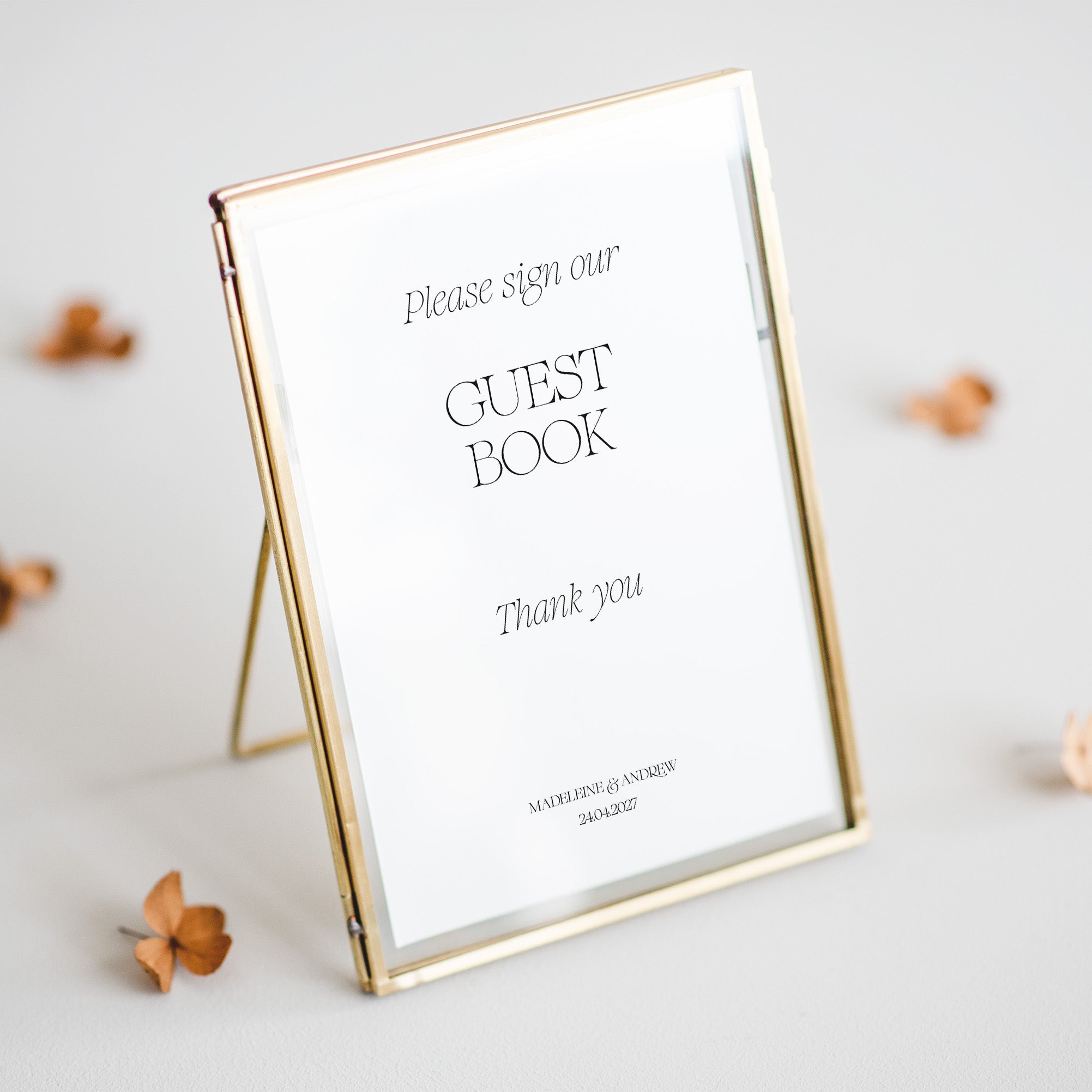 Personalised sign our guest book sign for wedding reception shown in gold frame on beige background