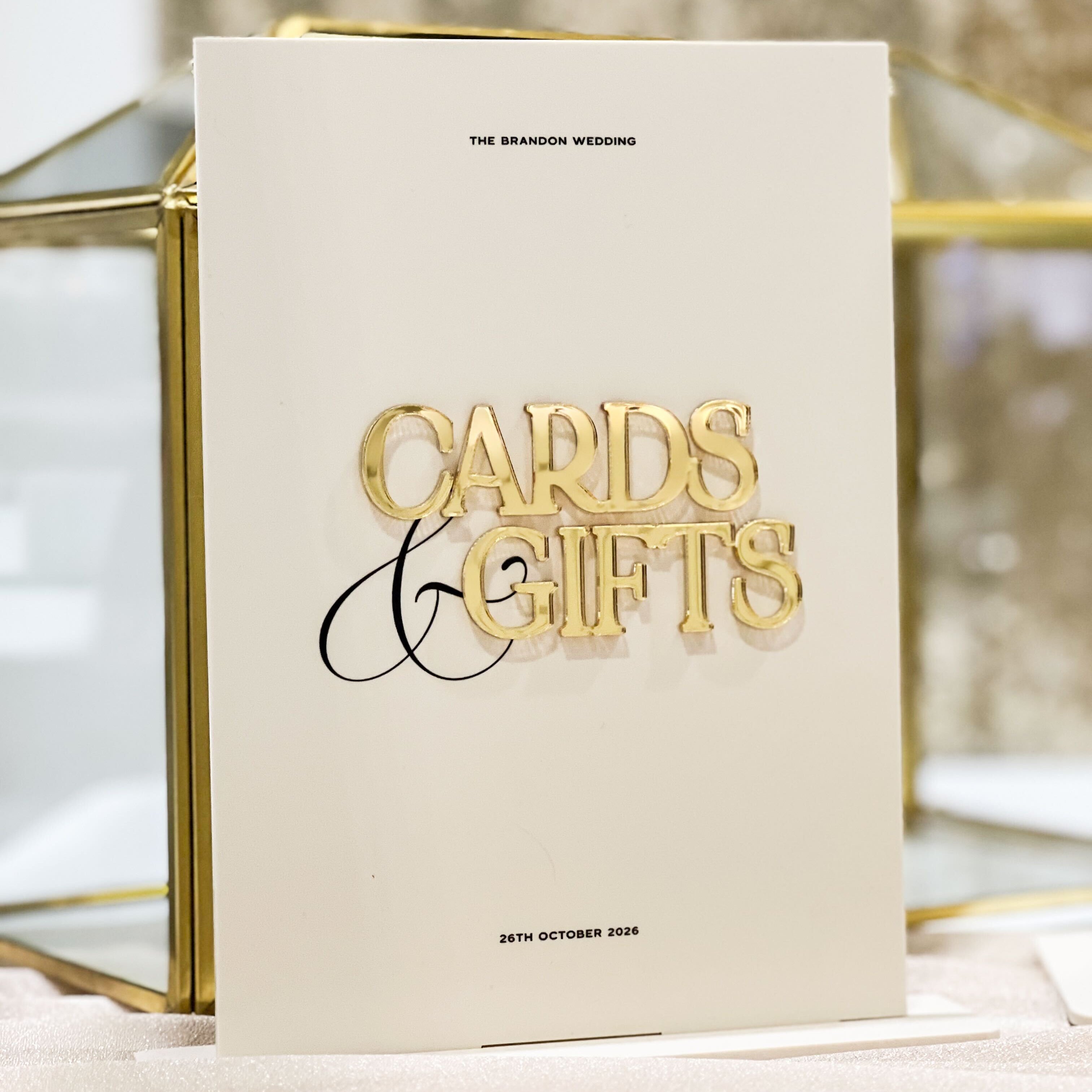 Beige acrylic with gold text 'Cards & Gifts' on a decorative stand.