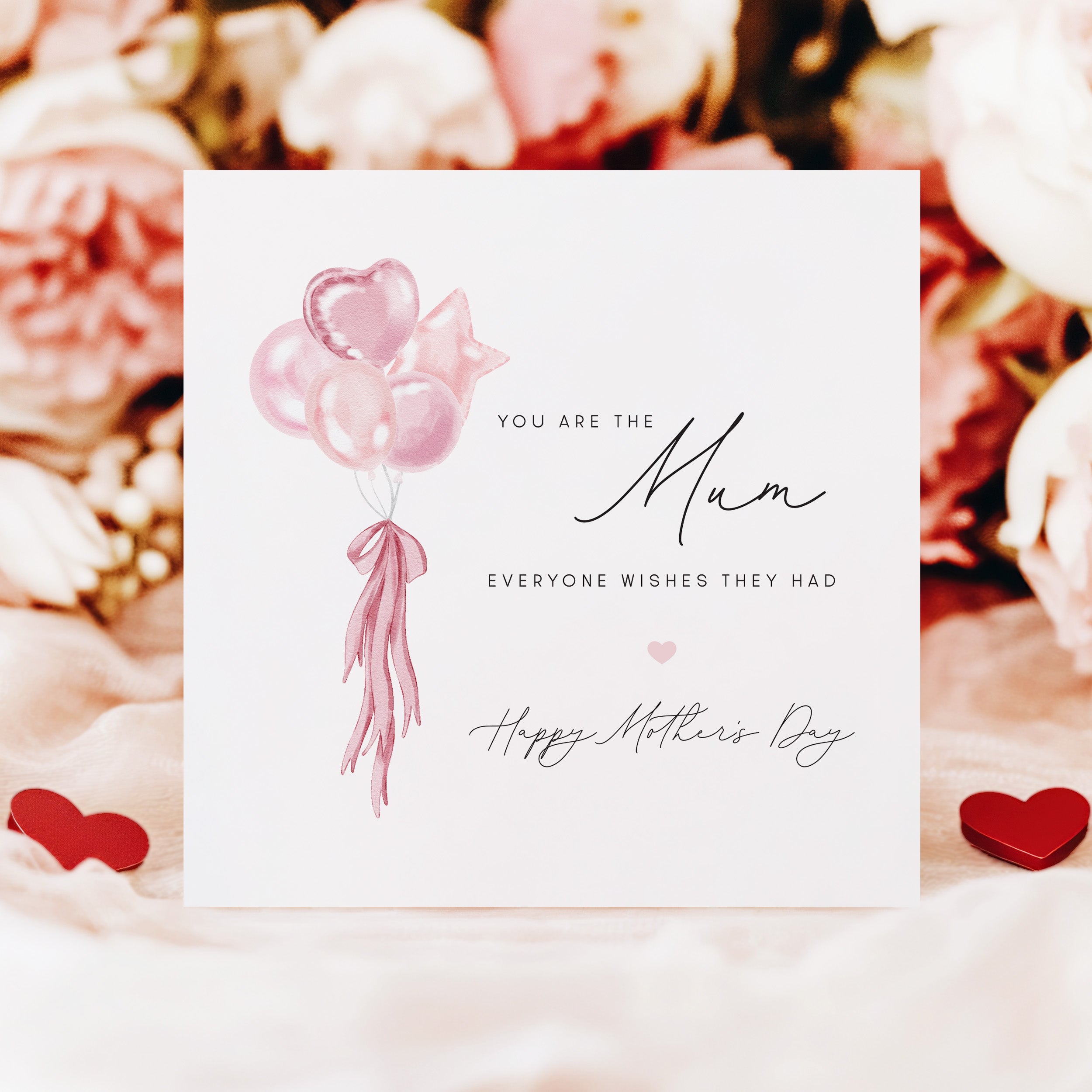 Greeting card with pink balloons and text on a floral background