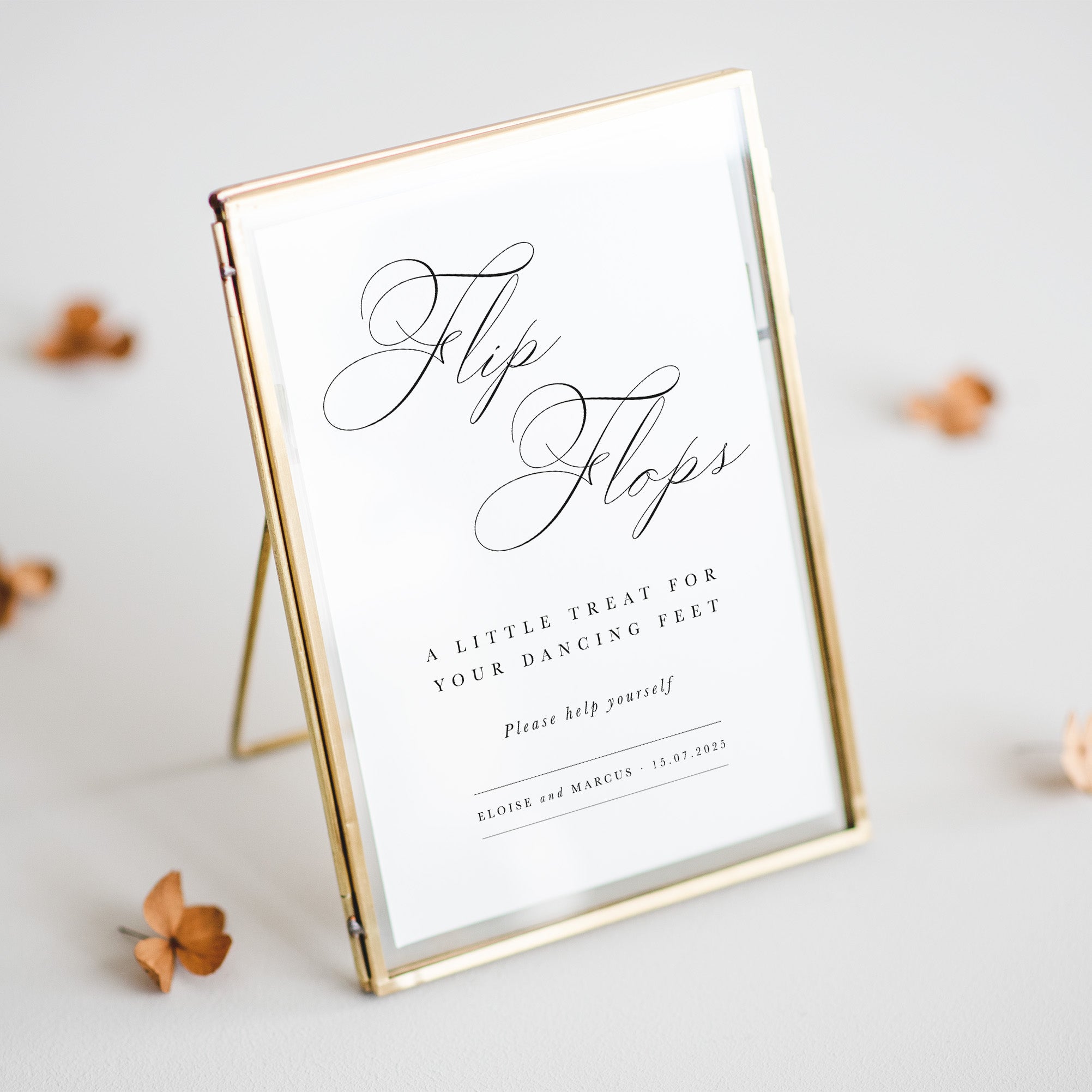 Gold-framed sign with 'Flip Flops' text on a light background