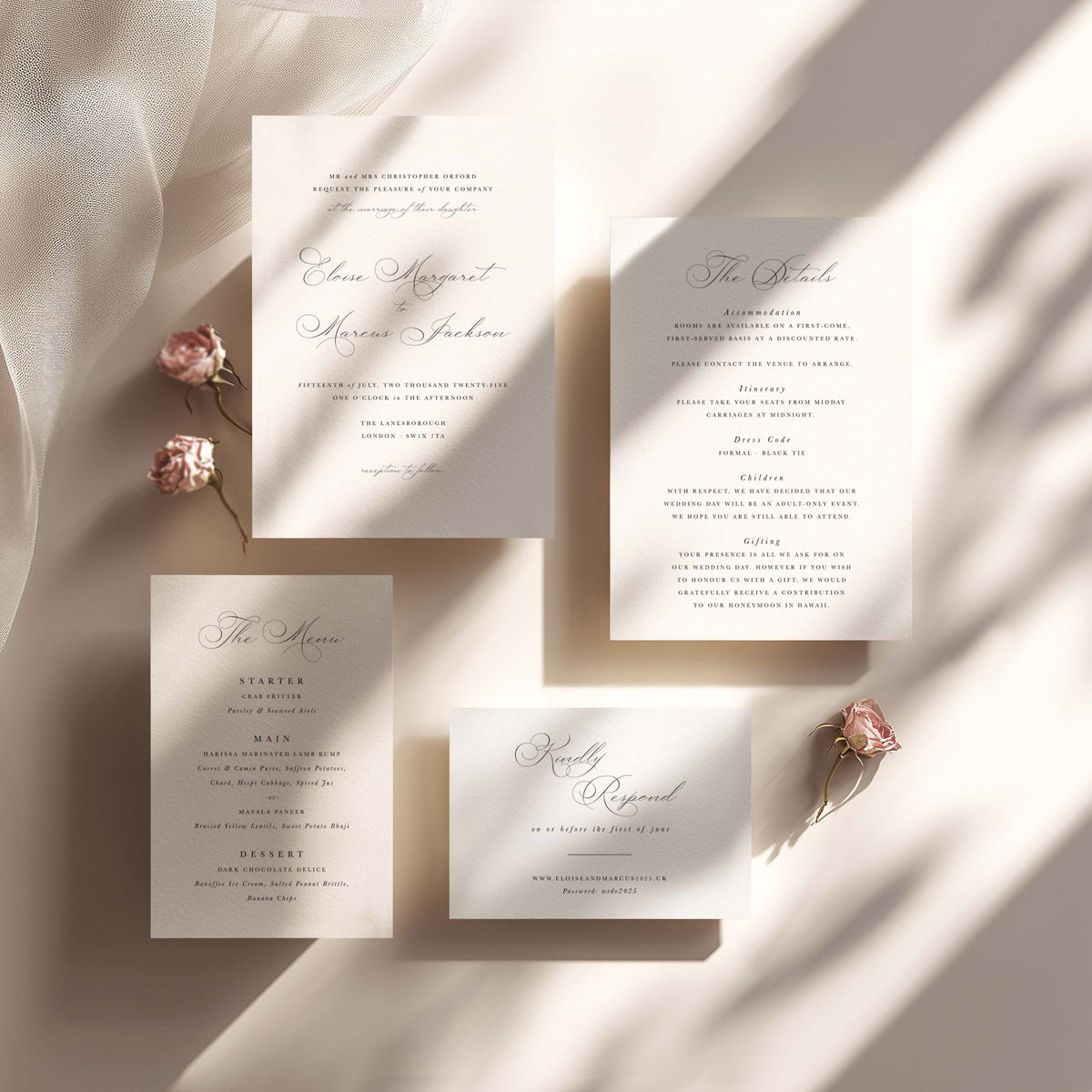 A coordinated wedding invitation suite arranged on a warm cream fabric background with soft diagonal shadows. The set includes a main invitation, an acceptance card, a marriage proposal card, a program/booklet, and small pink flowers used as styling props.