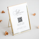 Gold-framed photo display with QR code and text on a light background