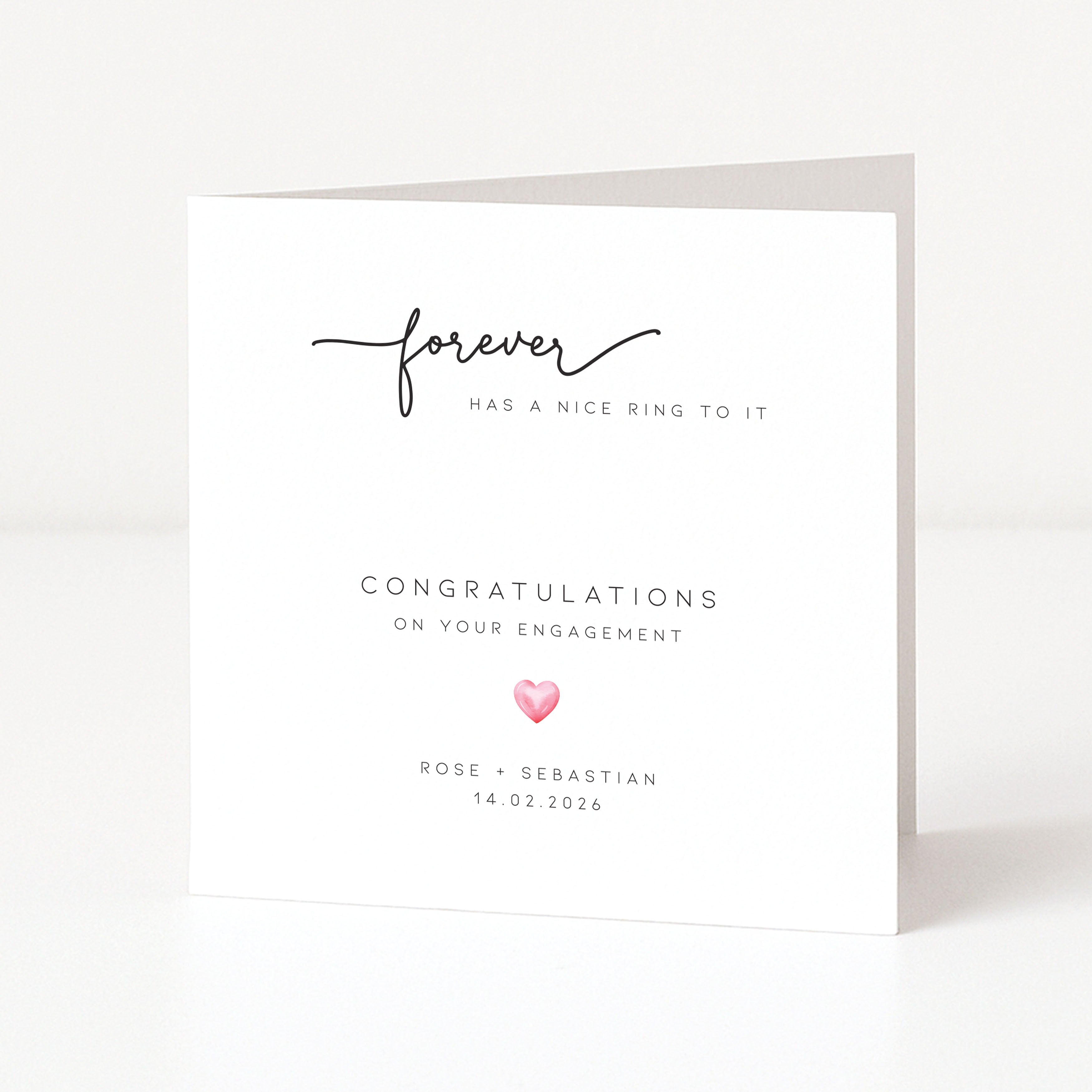 Engagement card with 'forever has a nice ring to it' text and a pink heart on a white background