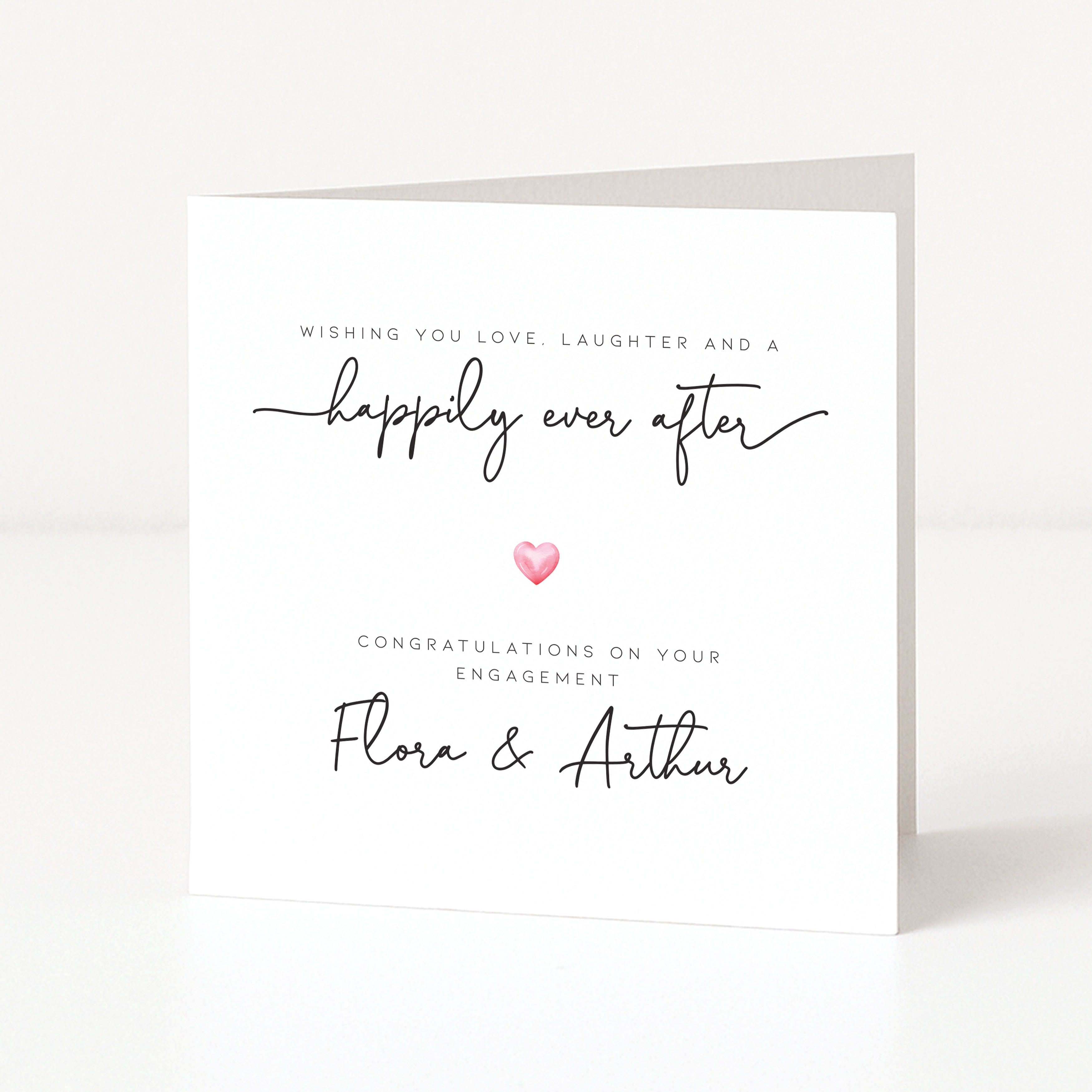 Engagement card with 'happily ever after' text and a heart symbol on a white background