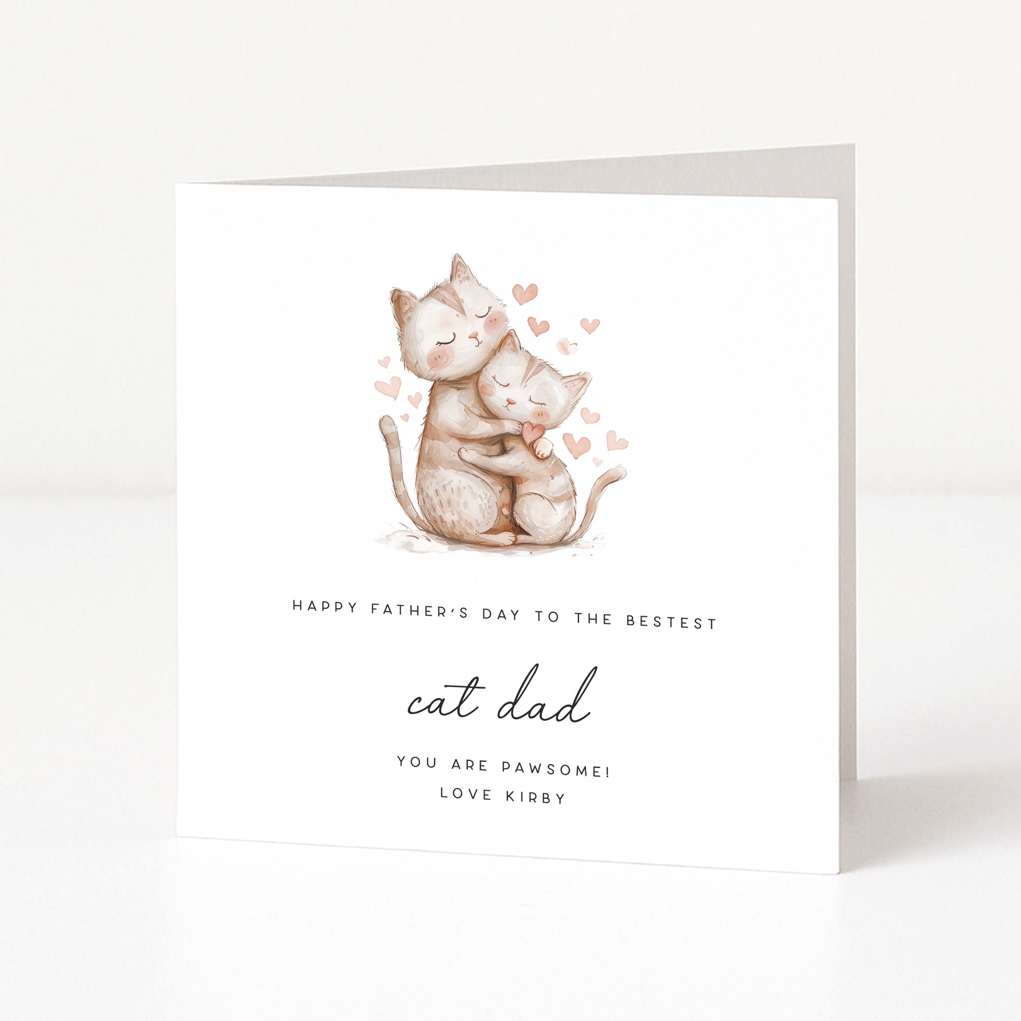 Greeting card with two cats hugging and hearts, text 'Happy Father's Day to the bestest cat dad you are pawsome! Love Kirby' on a white background.