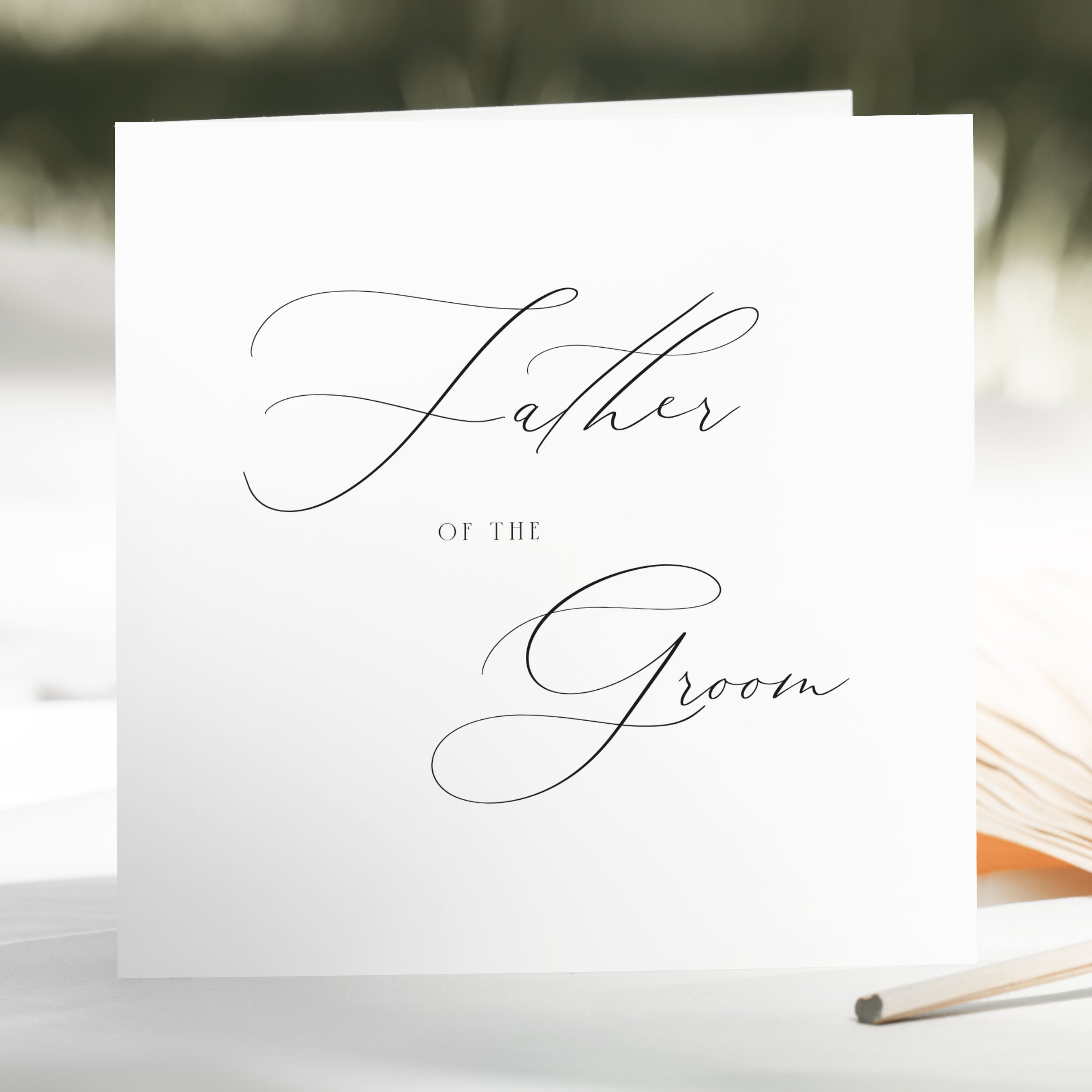 Greeting card with 'Father of the Groom' text on a blurred natural background